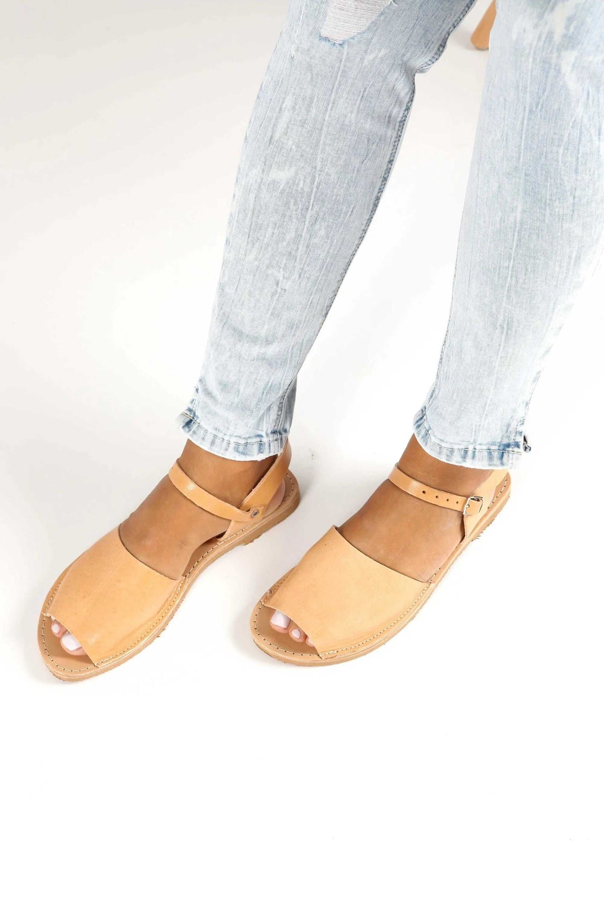 CLEO Handmade Greek Sandals in natural tan leather, with flat soles, broad toe straps and slim ankle straps.