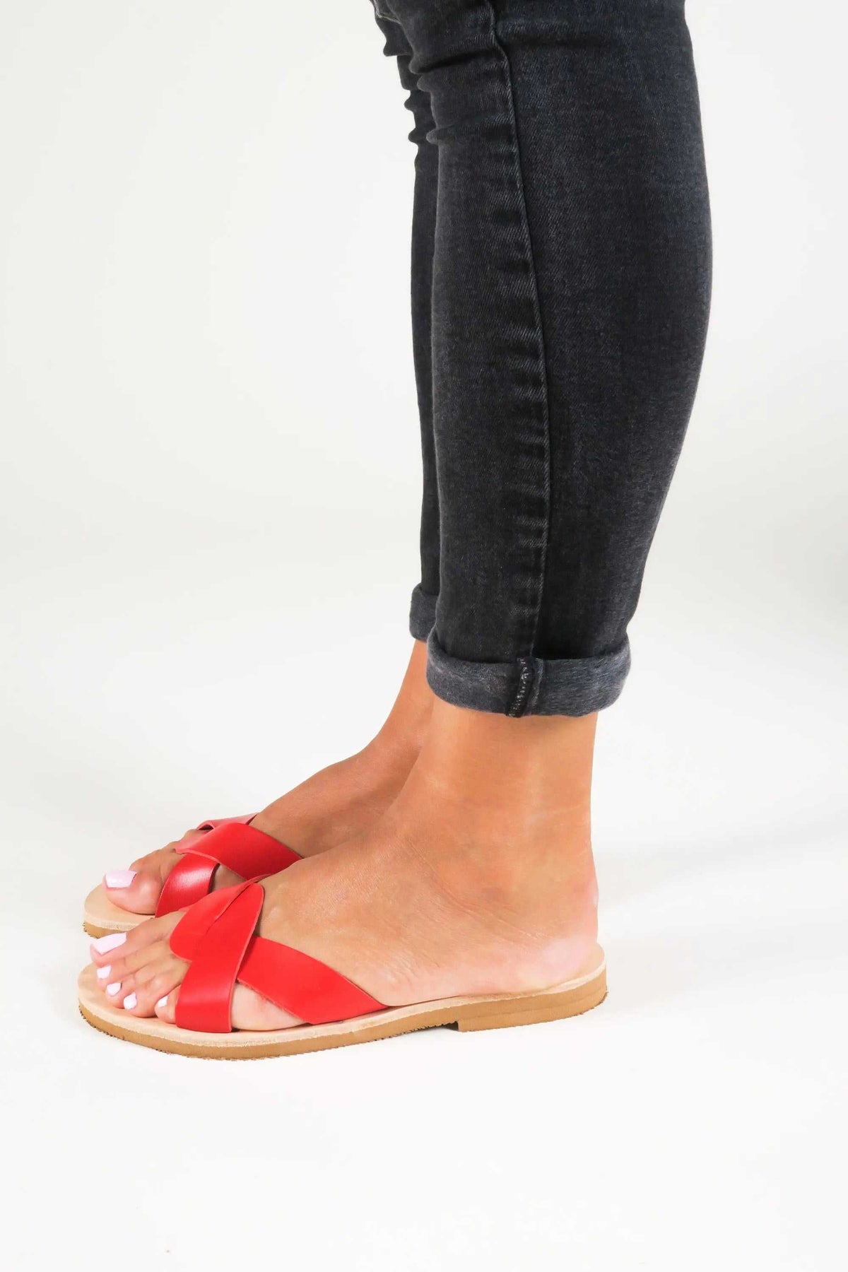 CYNTHIA Handmade Greek Sandals in red leather with crossed straps, open toes, and a flat rubber sole