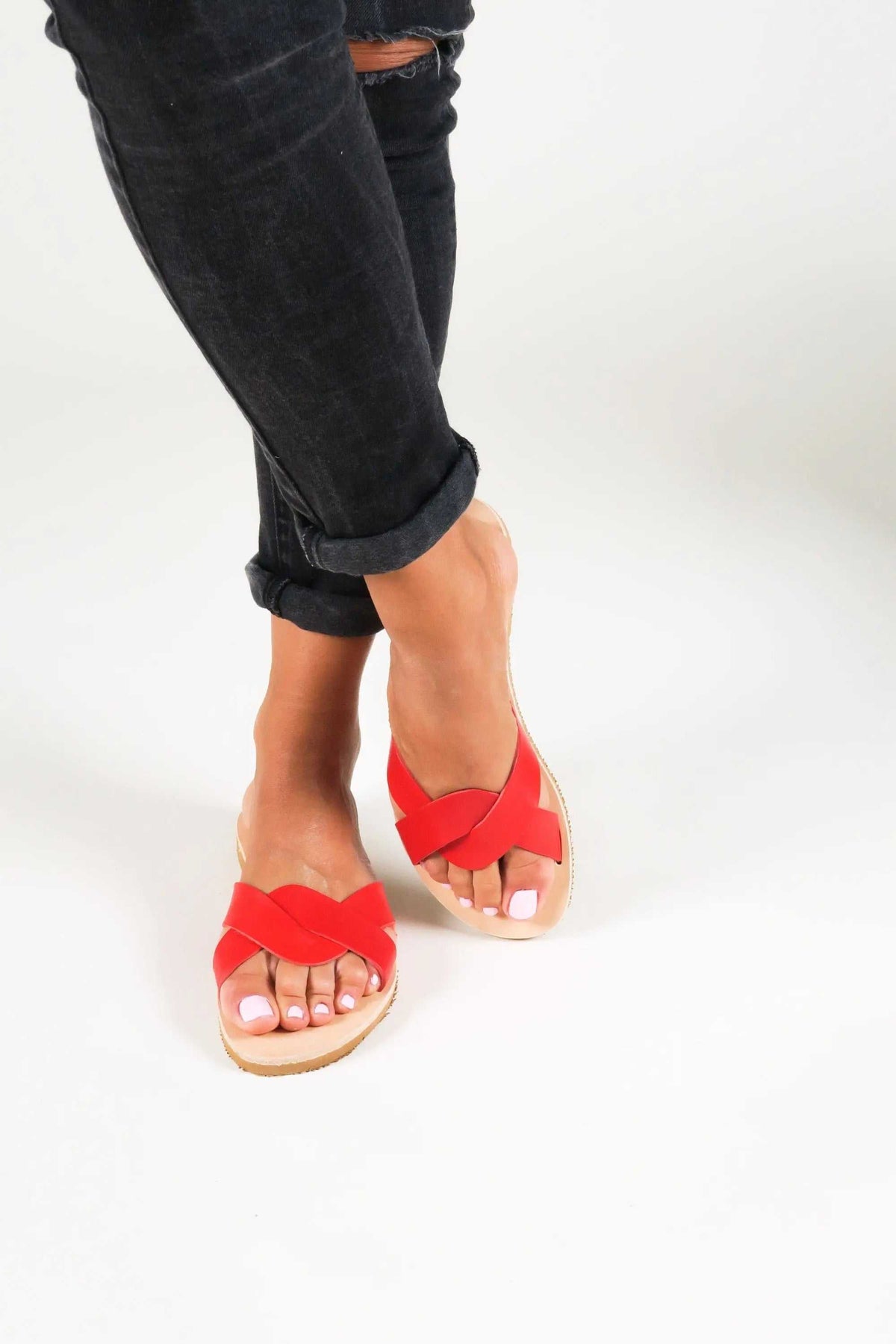 CYNTHIA Handmade Greek Sandals in bright red leather, with wide crossed straps and a natural-toned sole.