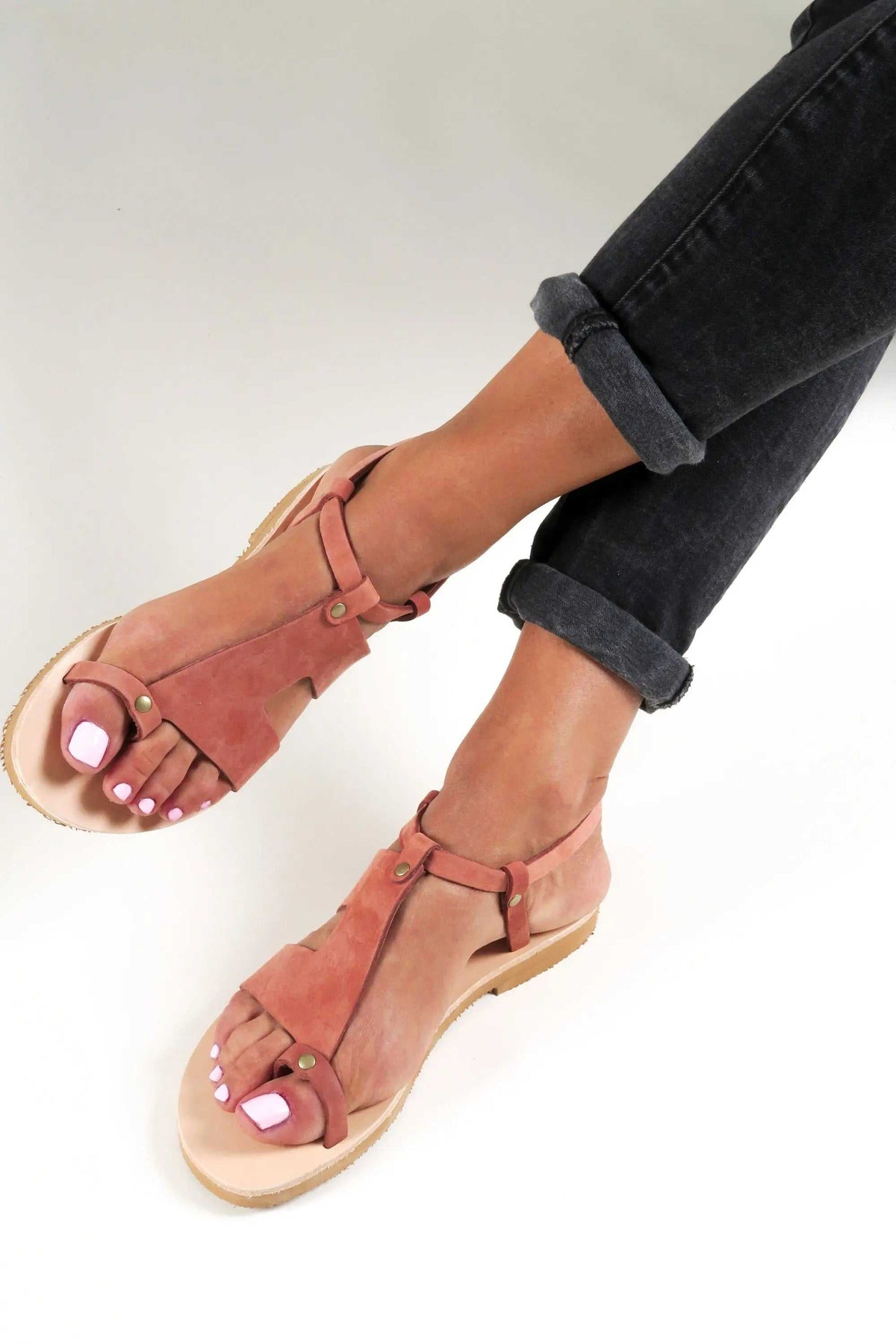 DELOS Handmade Greek Sandals in brick-red leather with slim strappy design, toe loops, metal rivets and natural soles