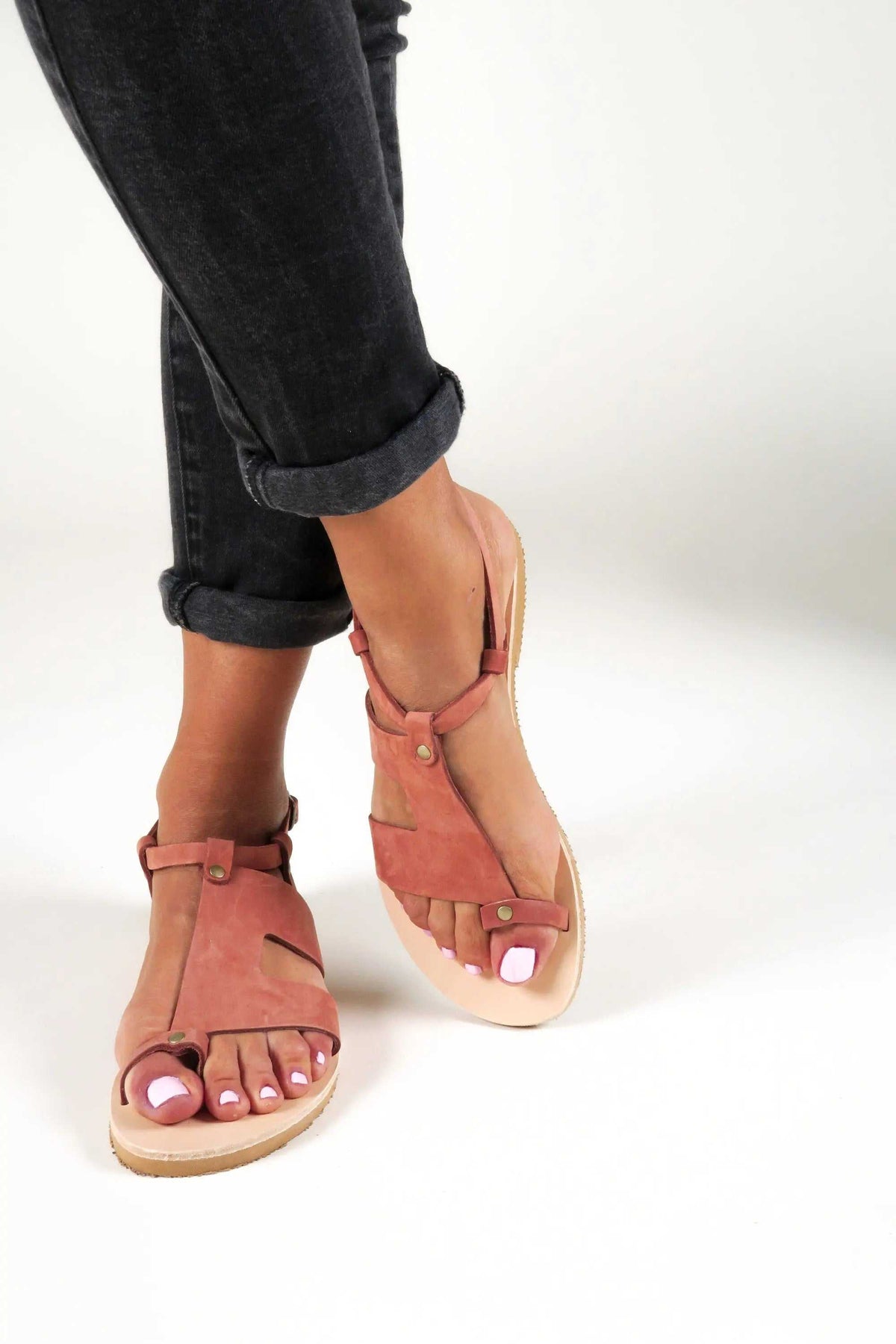 DELOS Handmade Greek Sandals in brick-red leather with slim straps, toe loops, buckle details and natural soles