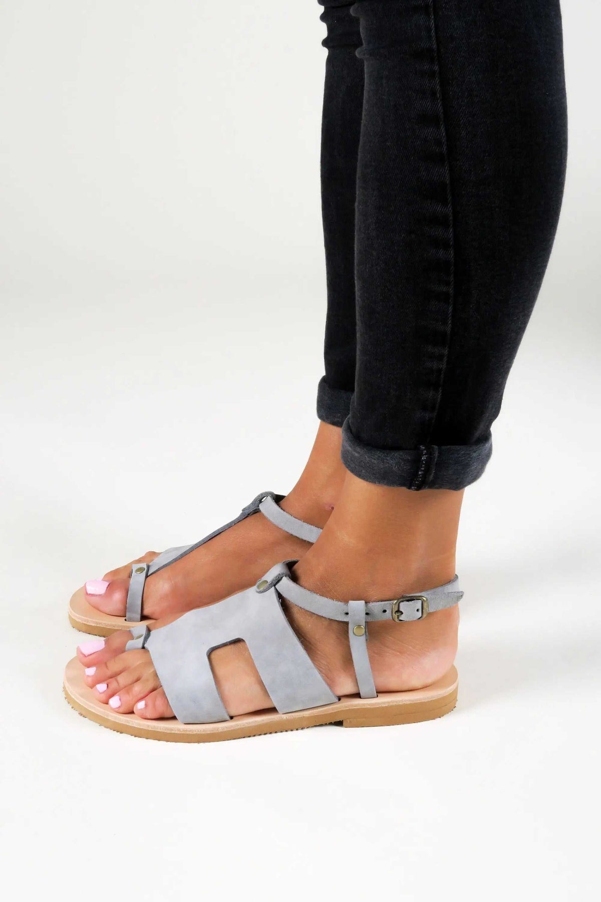 DELOS Handmade Greek Sandals in grey leather with slim straps, buckle closures, and a natural tan sole