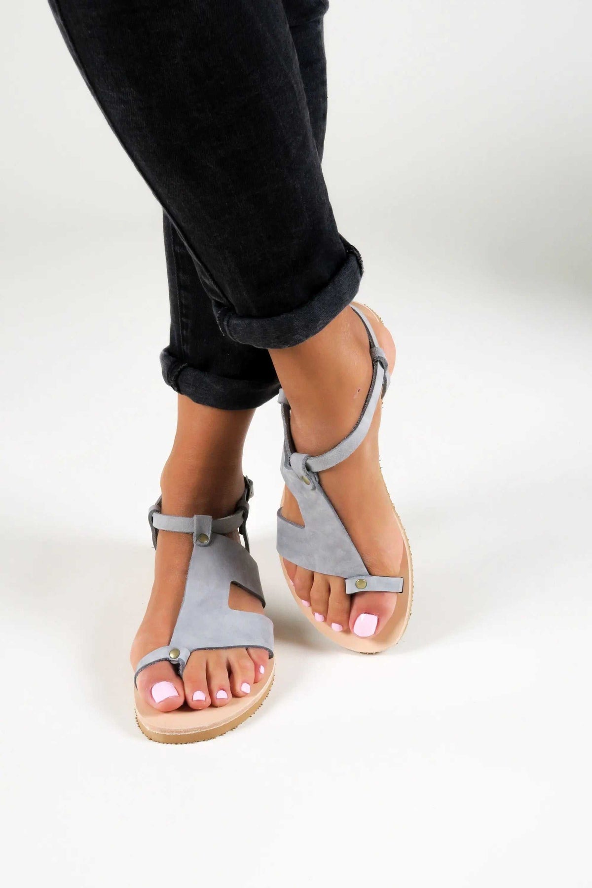 DELOS Handmade Greek Sandals in grey suede leather, with ankle straps, buckle fastenings and a tan sole.
