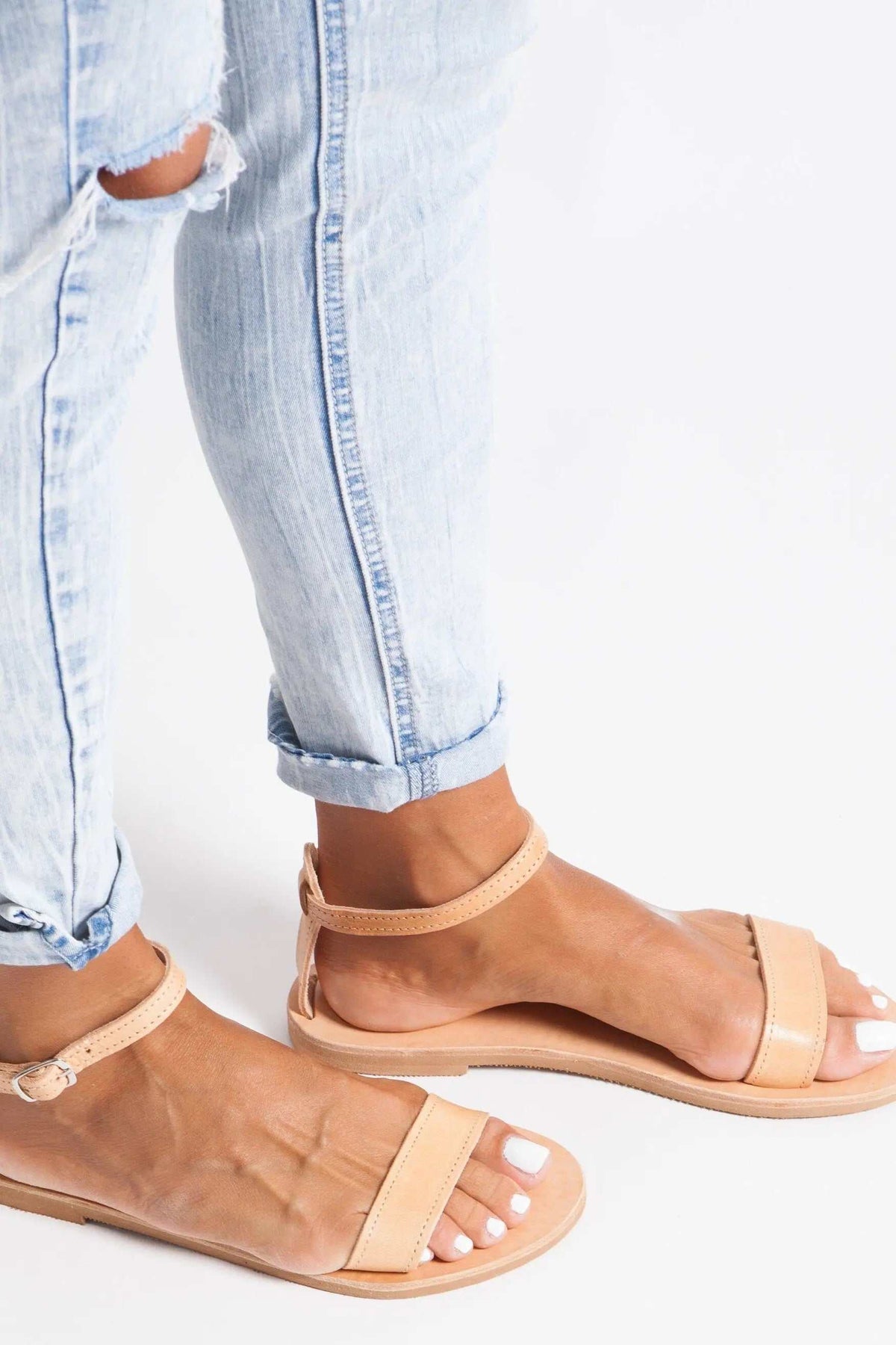 ELIA Handmade Greek Sandals in natural tan leather with slim straps, ankle loops and flat soles, worn on feet