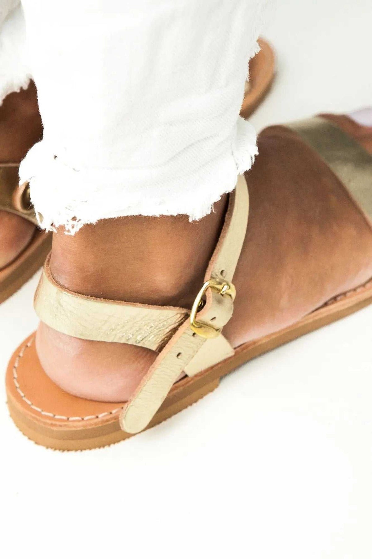 ELOUNDA Handmade Greek Sandals in beige leather with multiple straps, brass buckle, and stitched rubber sole