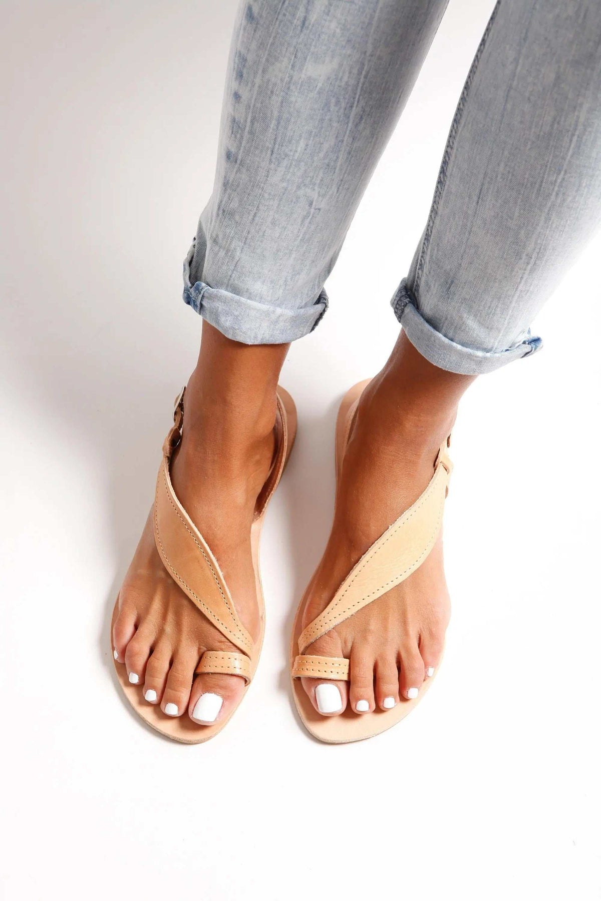 FILO Handmade Greek Sandals in natural tan leather with slim crossed straps, toe loops, and white soles