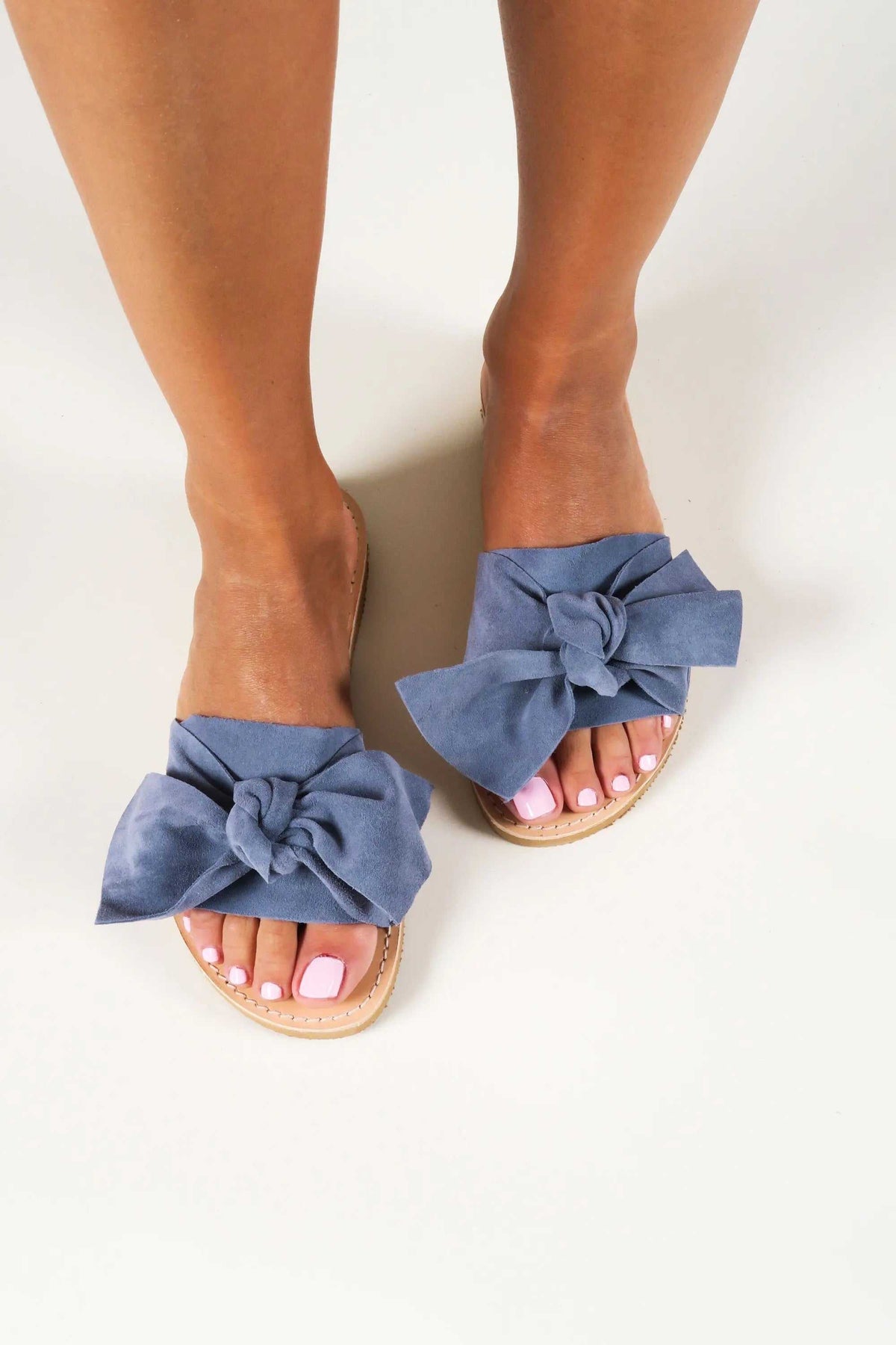 FIOGOS Handmade Greek Sandals in blue denim suede with oversized bow straps and natural tan leather soles