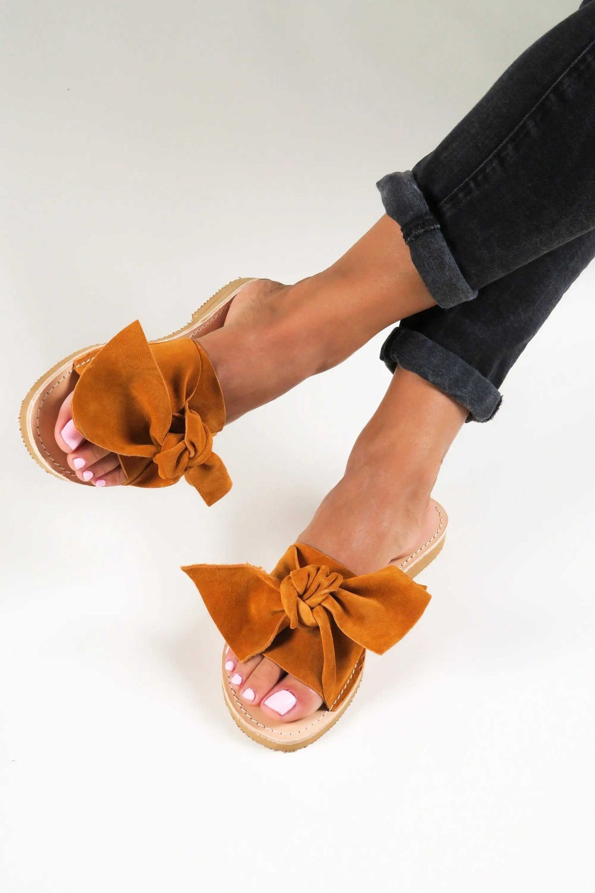 FIOGOS Handmade Greek Sandals in orange-brown suede with oversized bow straps and natural leather soles