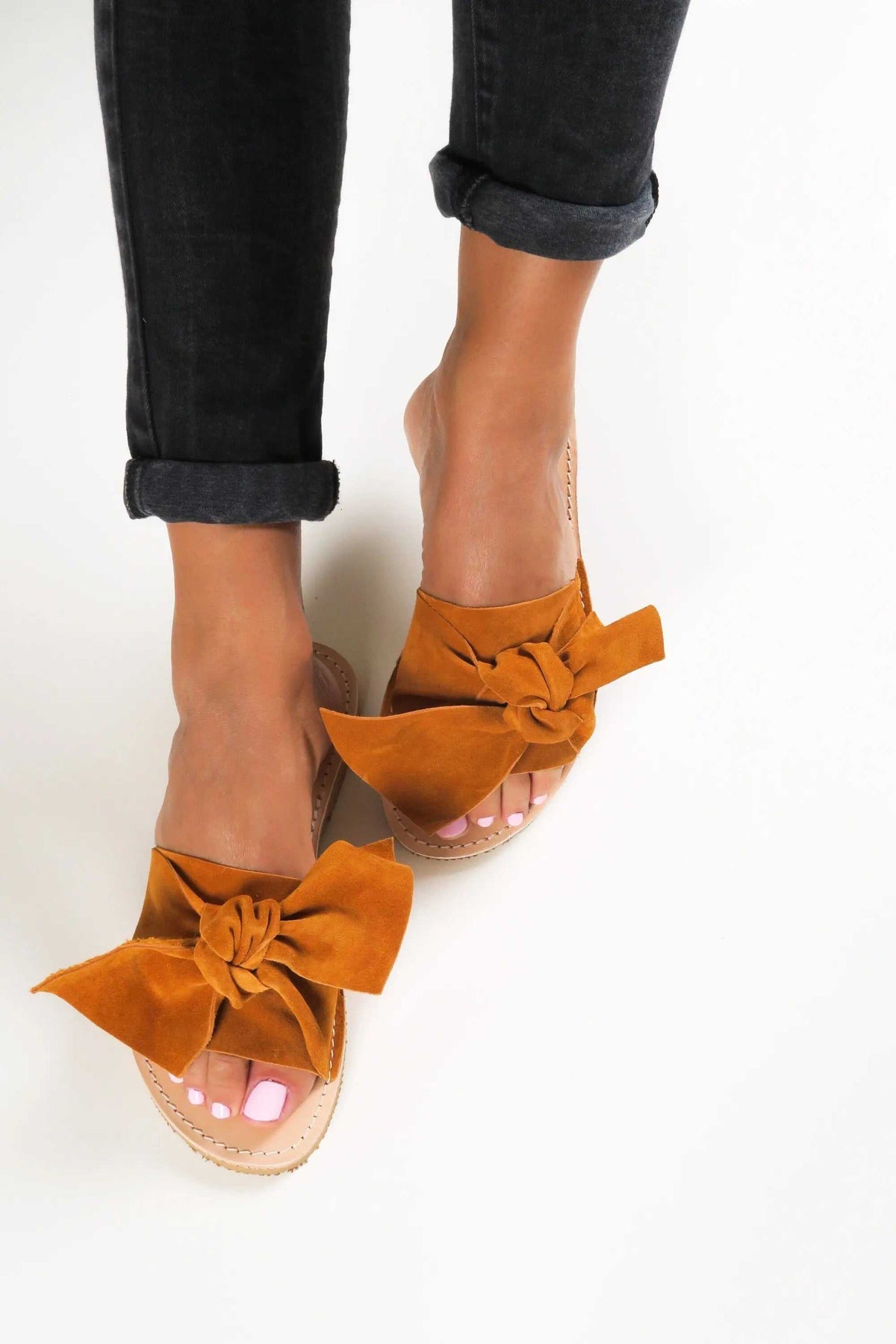 FIOGOS Handmade Greek Sandals in paprika orange suede, featuring oversized bow straps and a natural leather sole