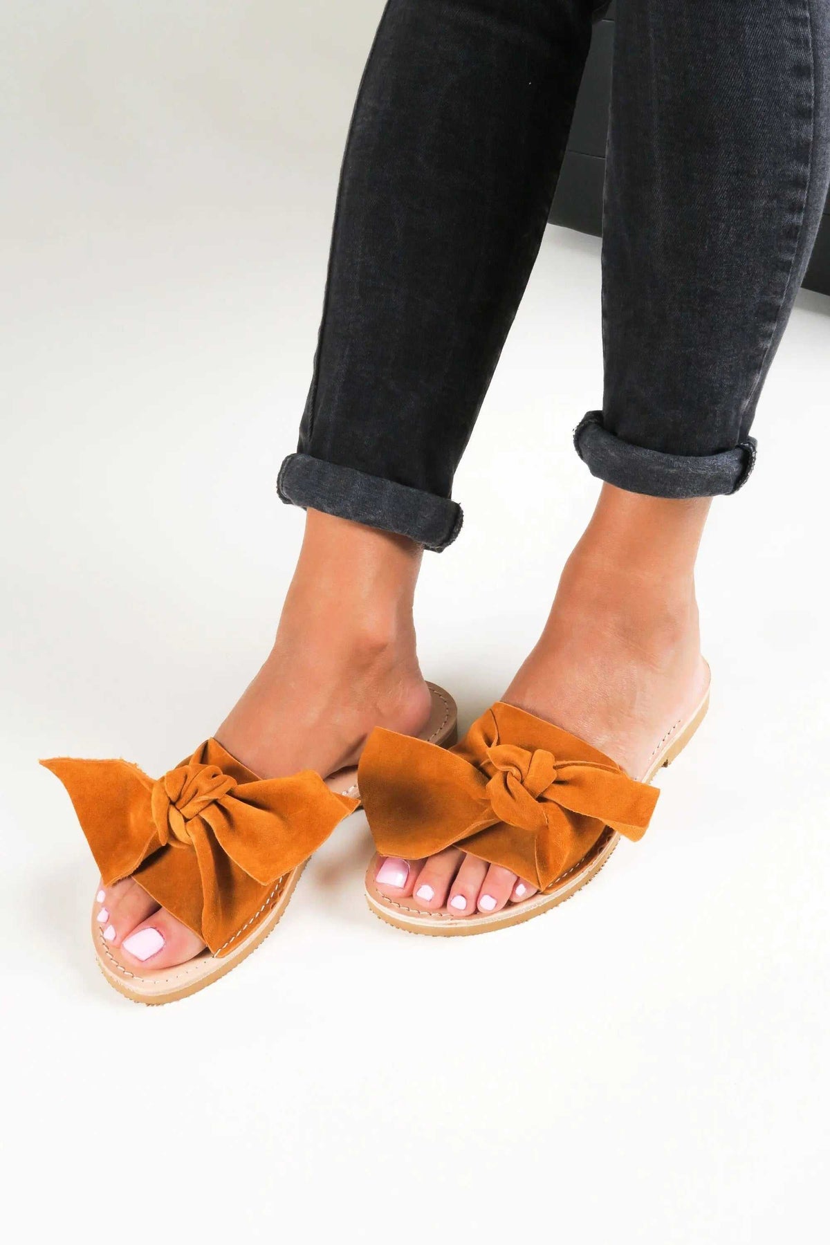 FIOGOS Handmade Greek Sandals in paprika orange suede with oversized bow straps and tan leather soles