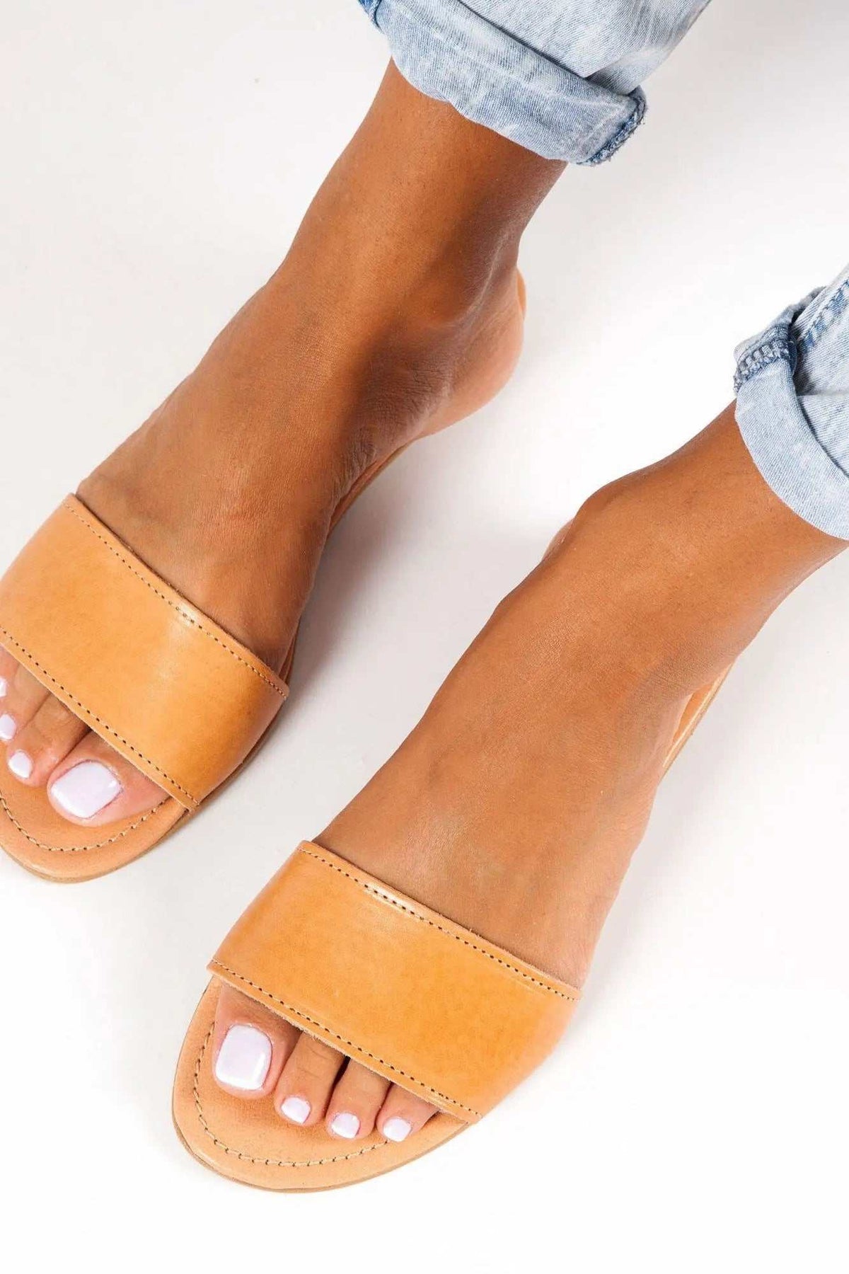 HYDRA Handmade Greek Sandals in tan leather with a wide stitched strap, open toes and a flat sole