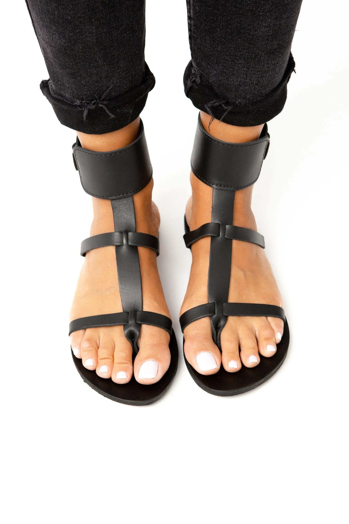 IFESTOS Handmade Greek Sandals in black leather with ankle cuffs, T-bar straps, and open toes