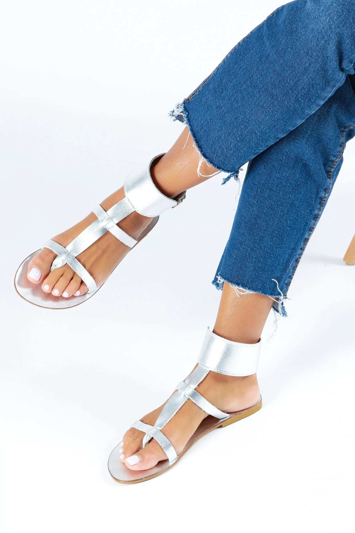 IFESTOS Handmade Greek Sandals in metallic silver leather with a flat sole, open toes, and multiple ankle and foot straps