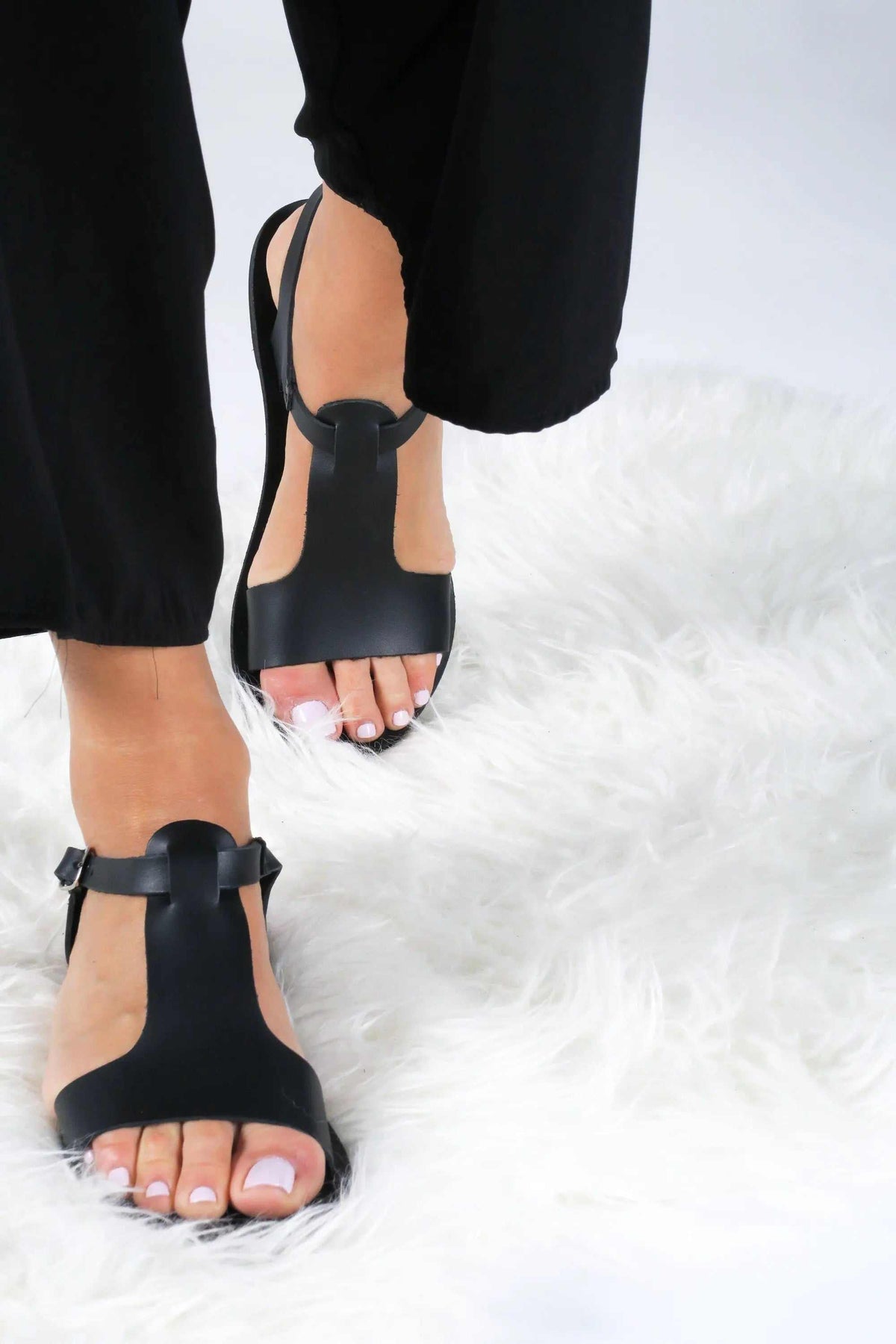 IFIGENE Handmade Greek Sandals in black leather with strappy design, open toes, and distinctive round front detail