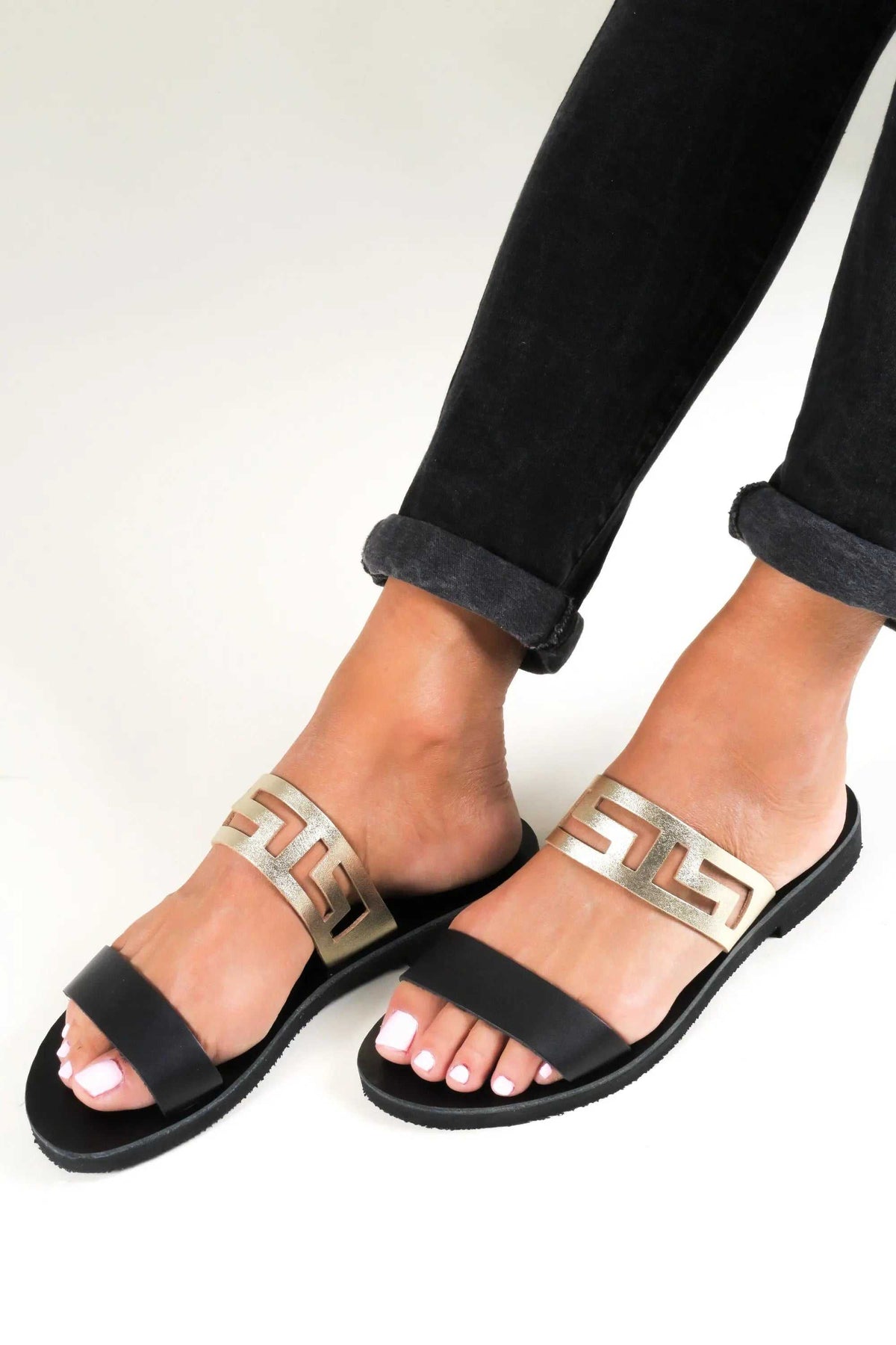 KNOSSOS Handmade Greek Sandals in black leather with gold meander-pattern straps and flat rubber soles