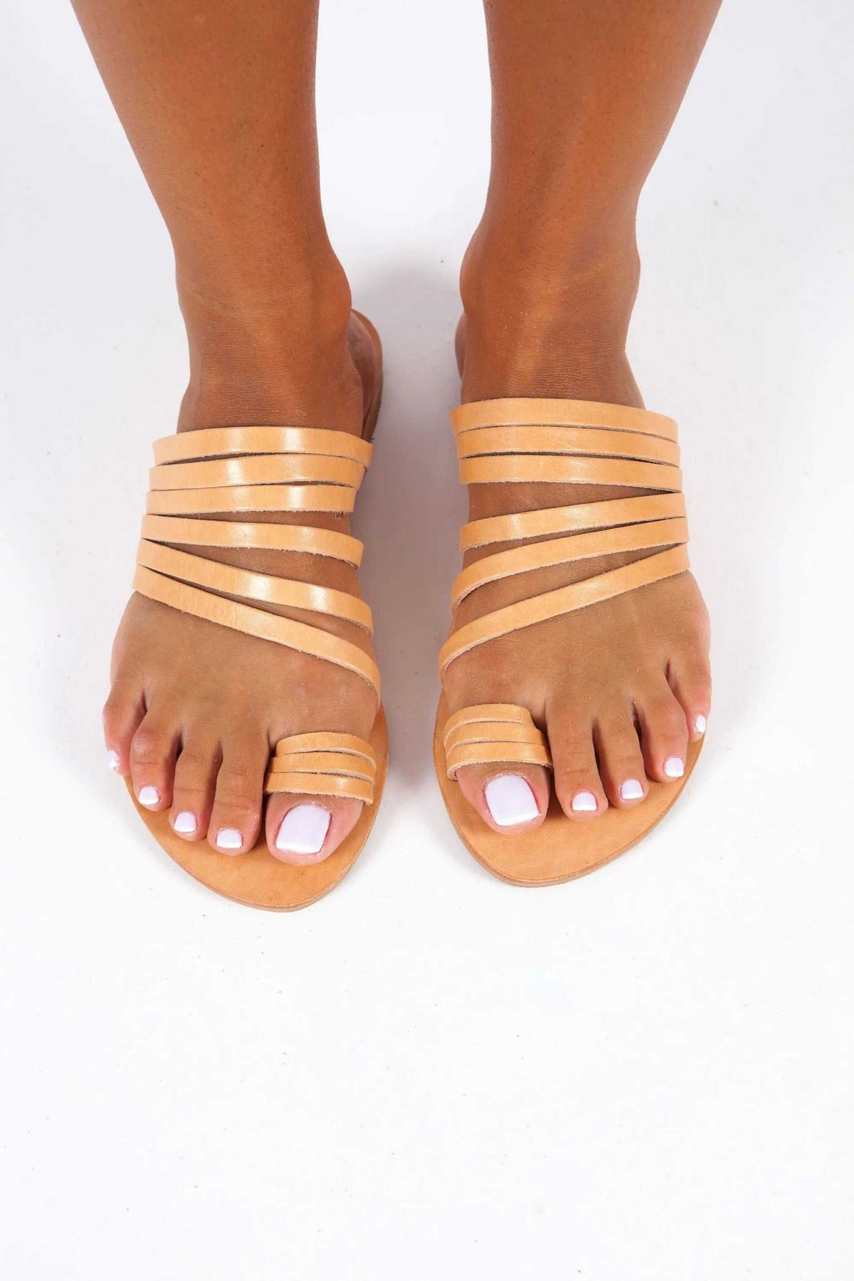 KYTHNOS Handmade Greek Sandals in natural tan leather, with slim crisscross straps and open toes.