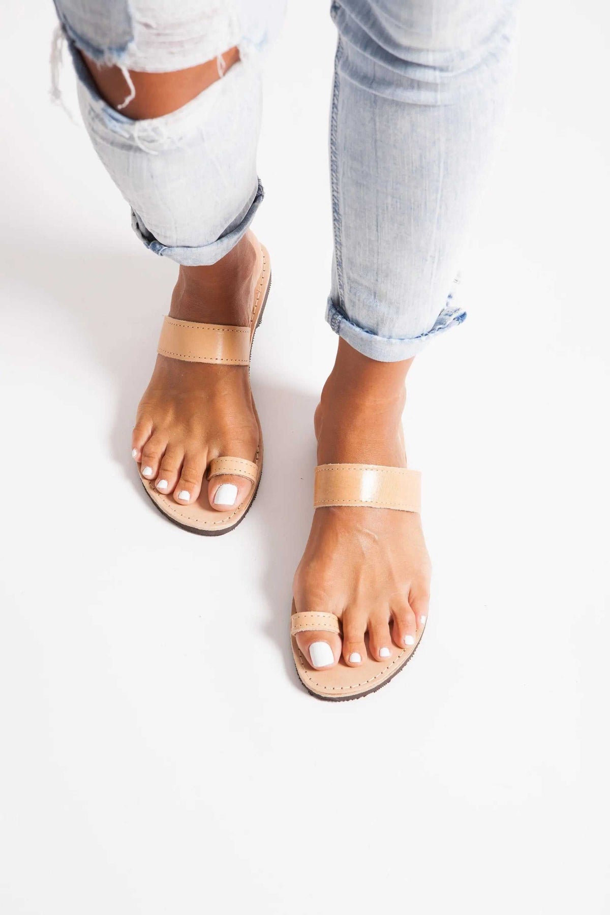 LEROS Handmade Greek Sandals in natural tan leather, flat open-toe design with broad straps and toe-ring detail.