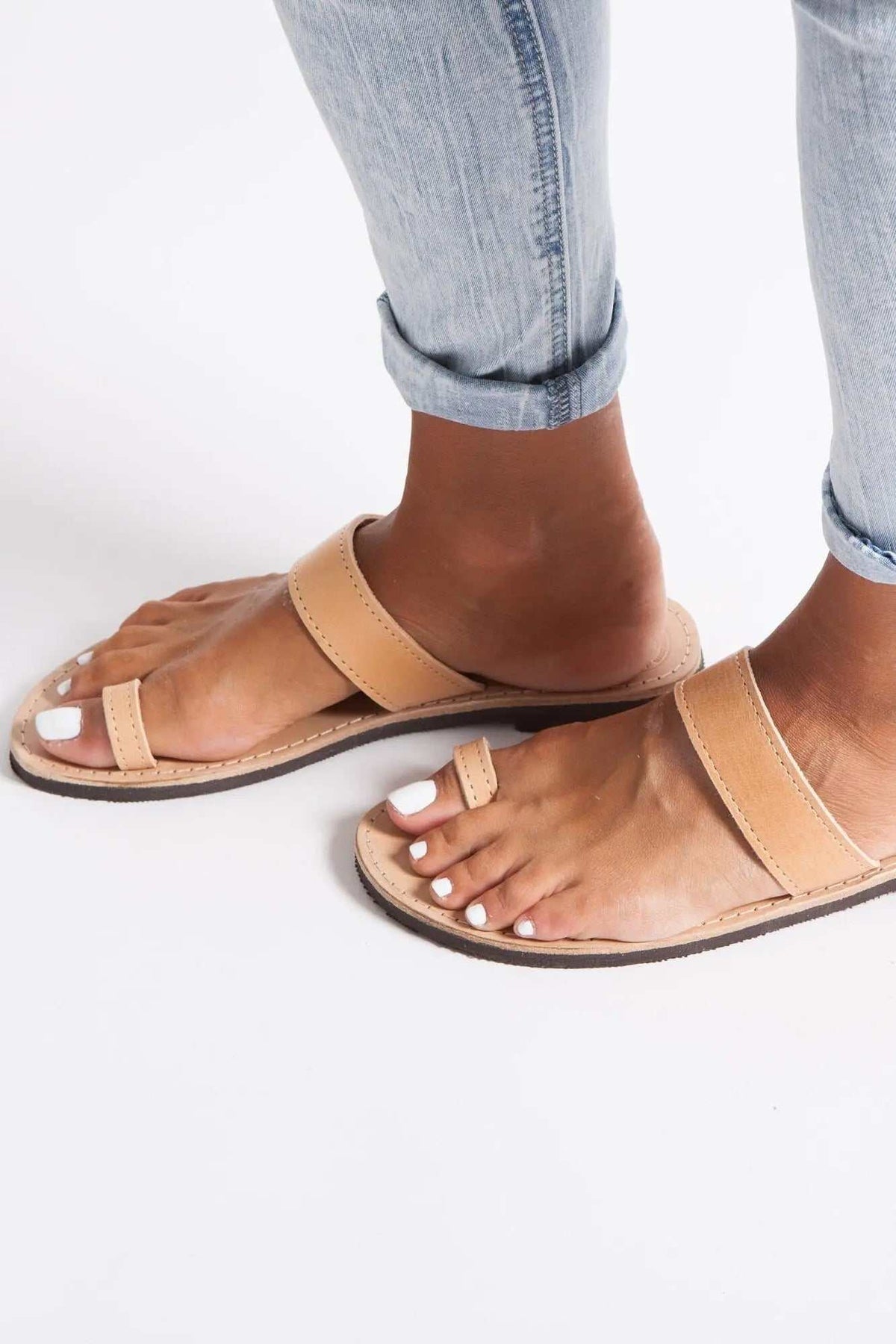 LEROS Handmade Greek Sandals in tan leather with flat soles, wide straps, and toe ring detail