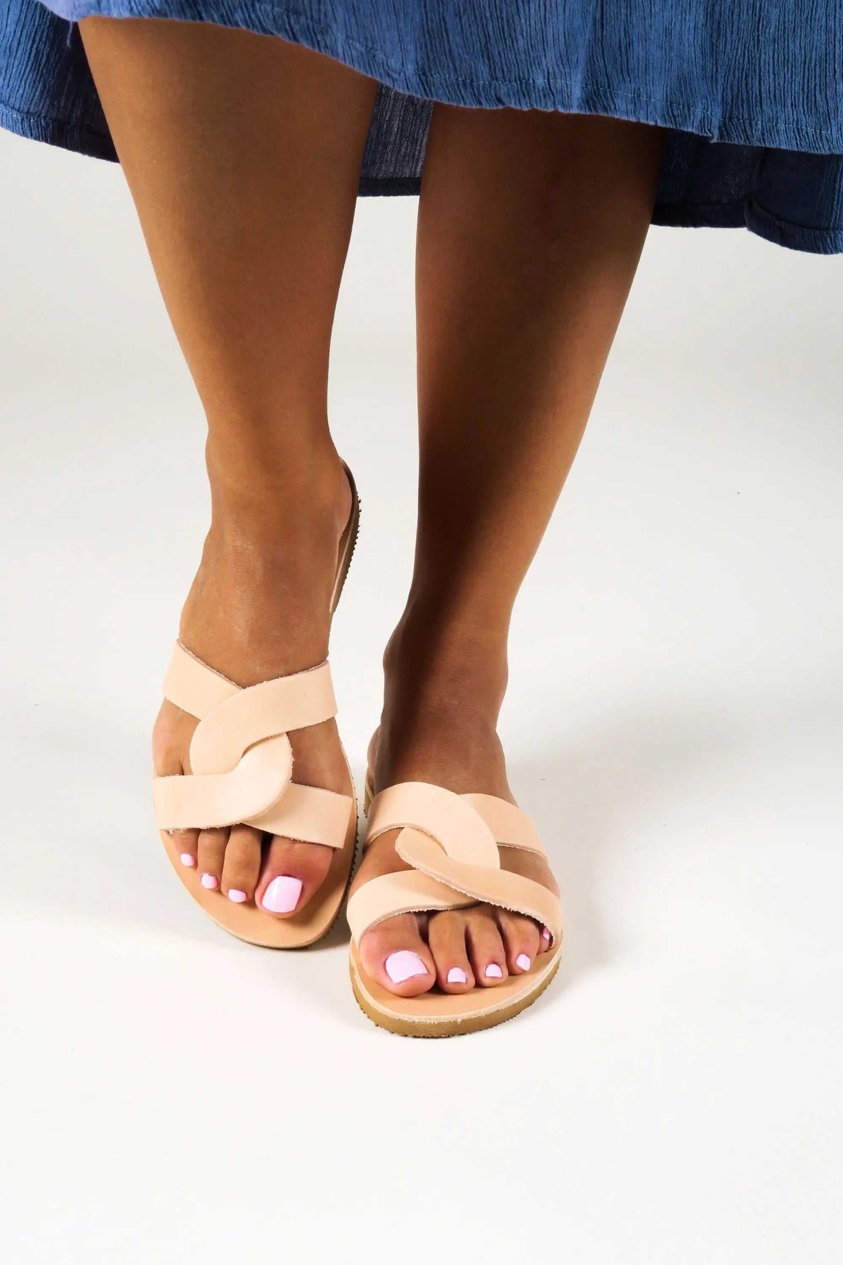 MYRINA Handmade Greek Sandals in natural tan leather, with wide crisscross straps and a flat brown sole.