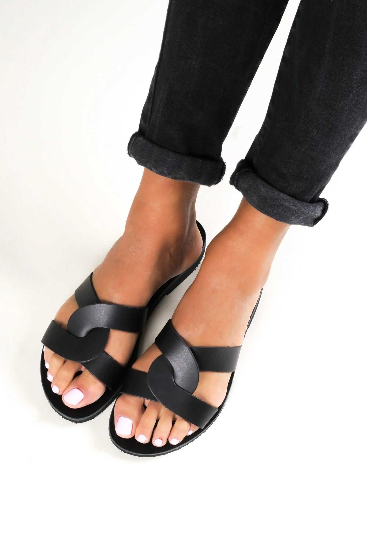 MYRINA Handmade Greek Sandals in black leather with broad crisscross straps, open toes and a flat sole