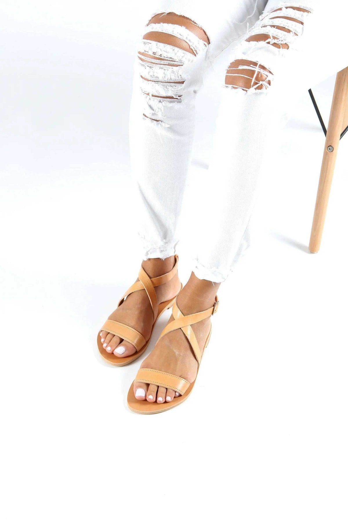 MYRTO Handmade Greek Sandals in natural tan leather, featuring slim crisscross straps and open toes.