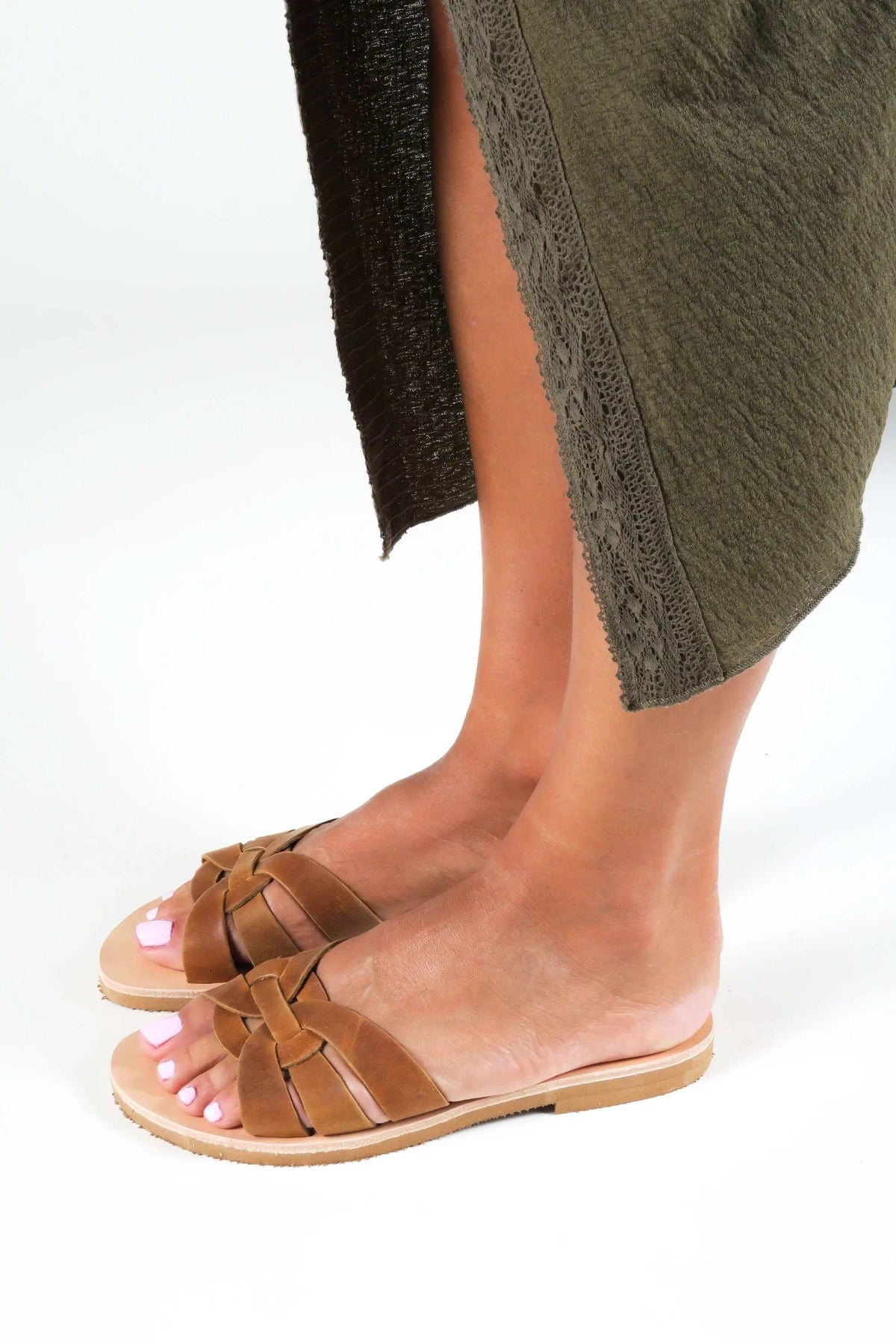 NAVARINO Handmade Greek Sandals in brown leather, featuring crossed straps and a flat sole with a slim profile