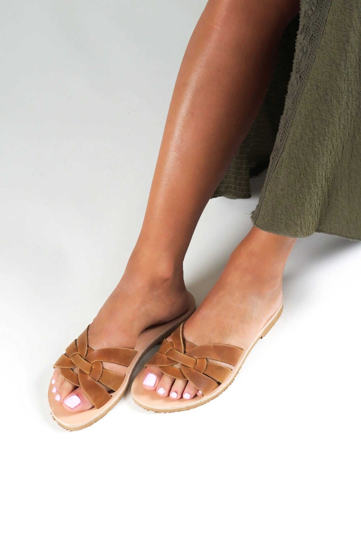 NAVARINO Handmade Greek Sandals in brown leather, featuring woven cross-over straps and a flat sole.