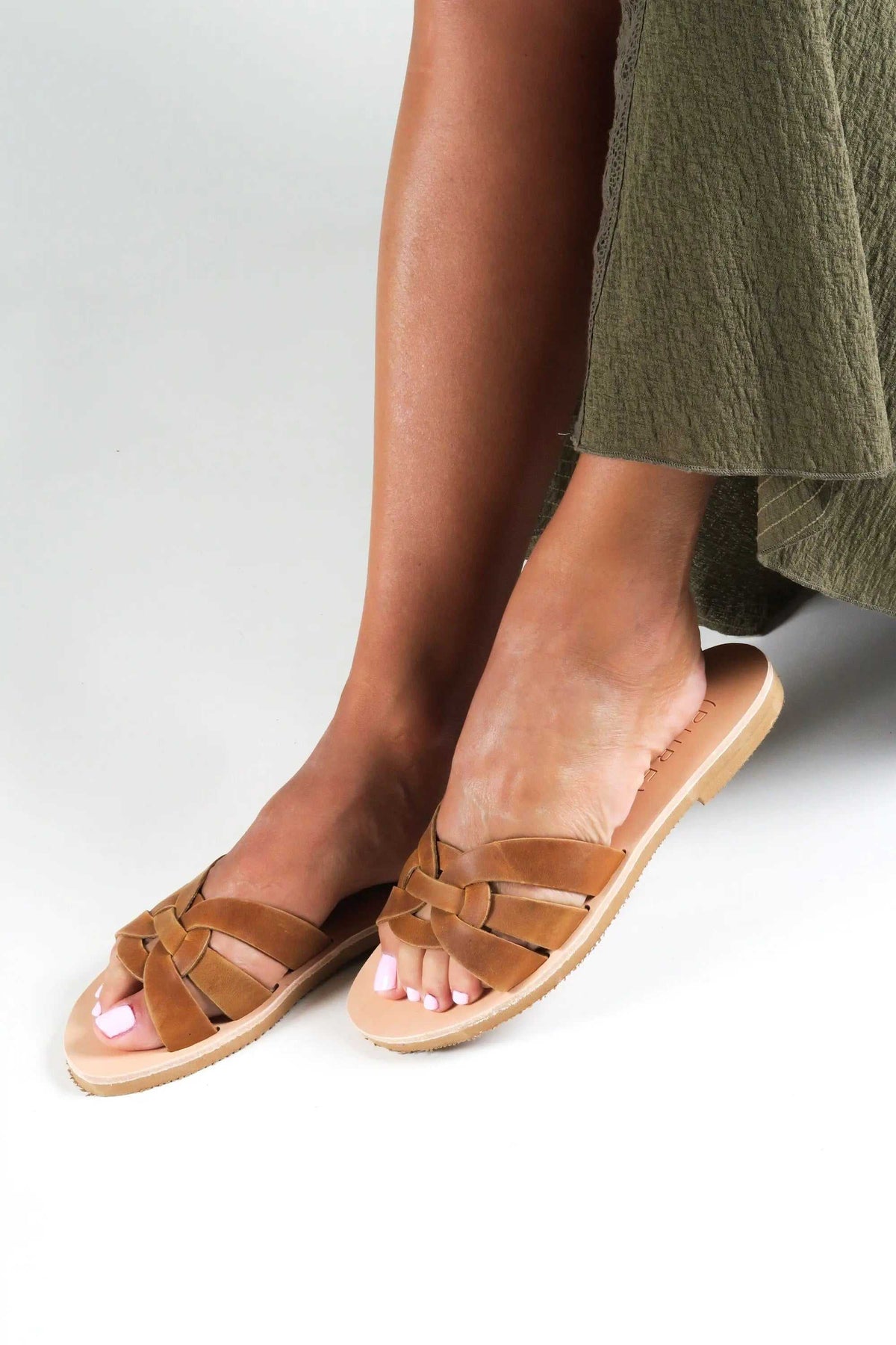 NAVARINO Handmade Greek Sandals in tan leather with braided straps, open toes, and flat light-colored soles