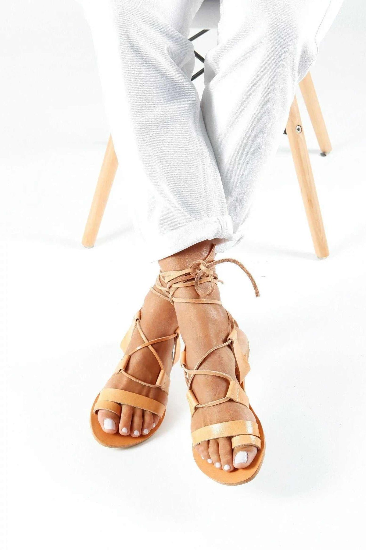 NEFELI Handmade Greek Sandals in natural tan leather, with open toes, slim crisscross straps and lace-up ankle ties.
