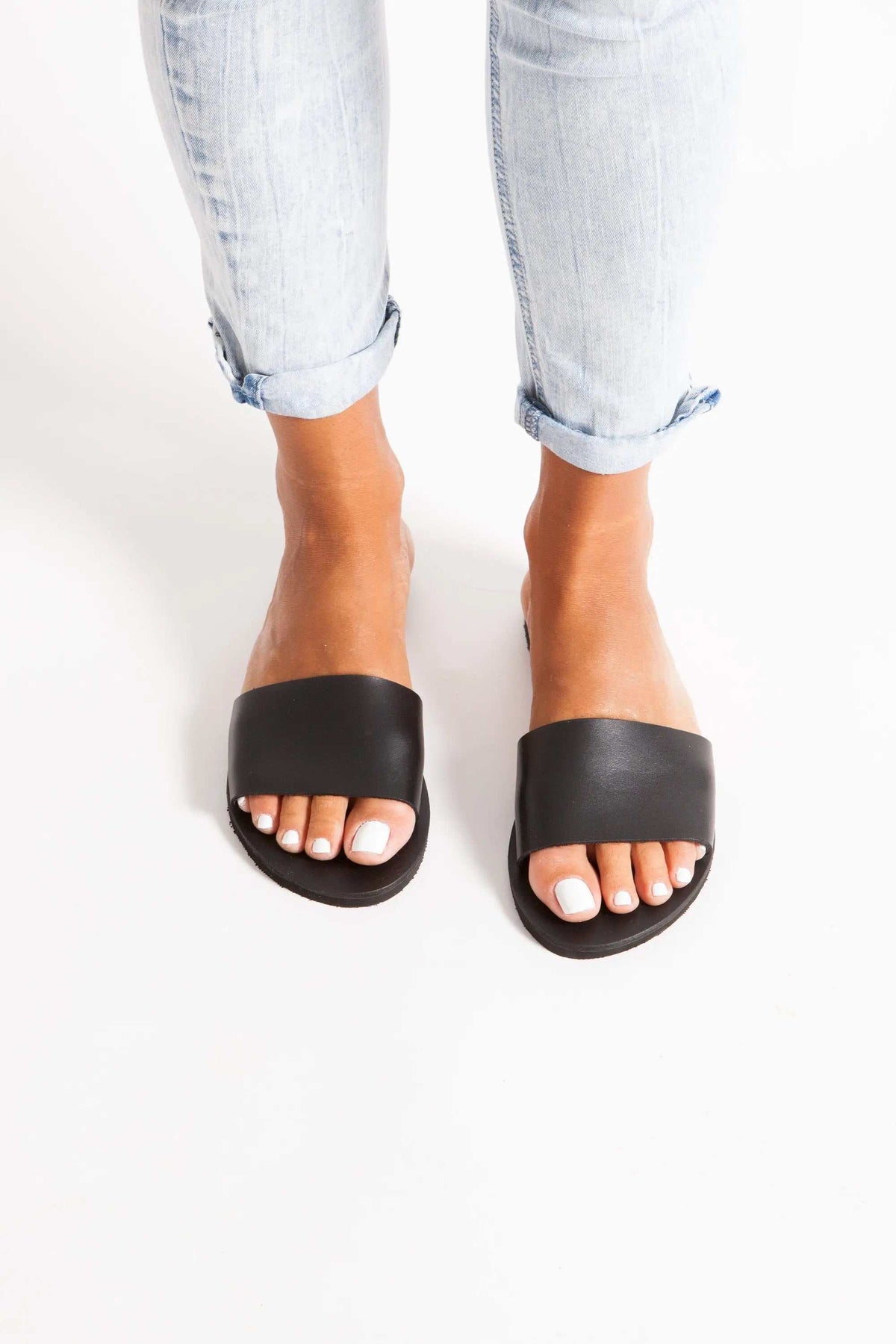 PAROS Handmade Greek Sandals in black leather with wide slip-on straps, flat soles and open toes