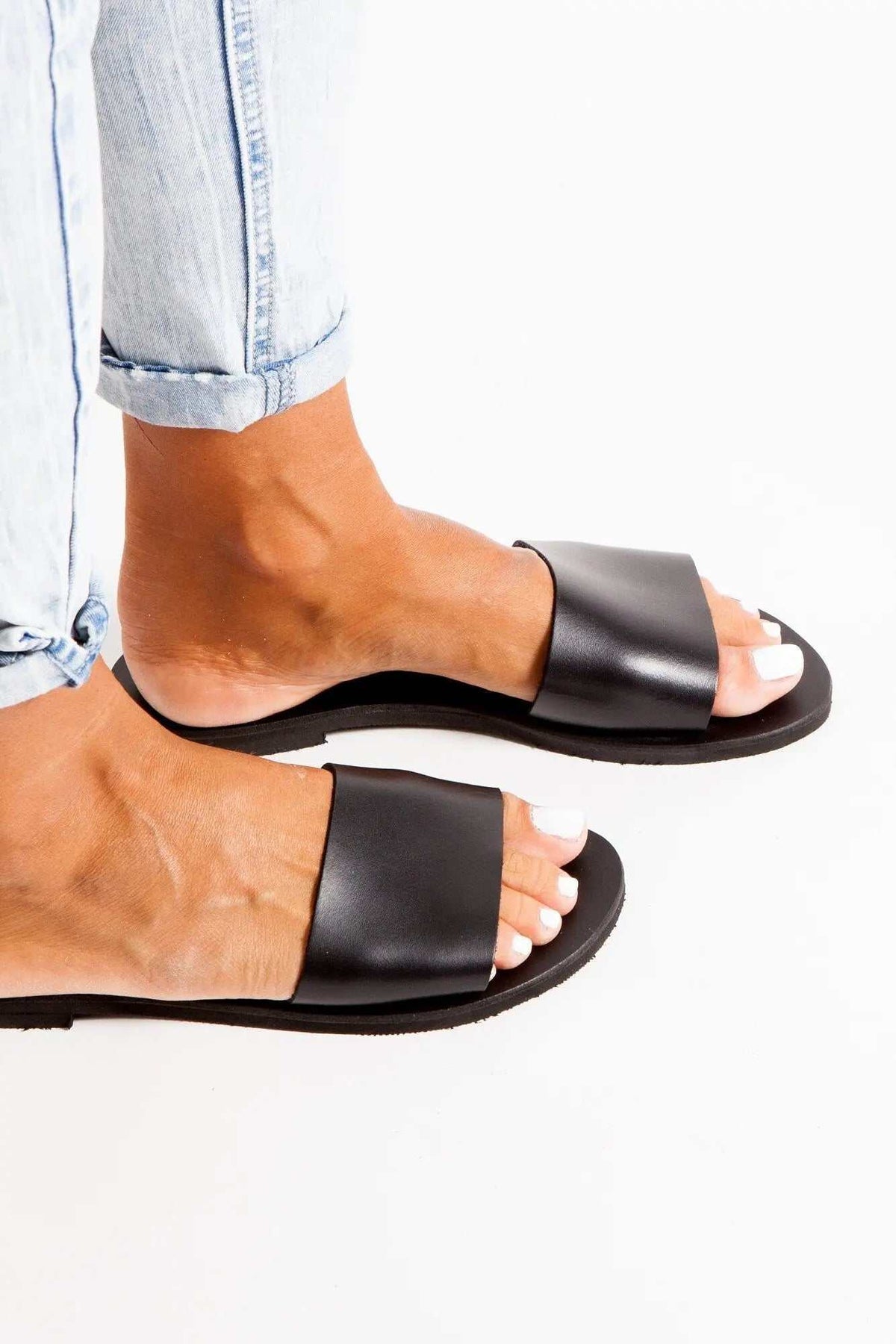 PAROS Handmade Greek Sandals in black leather with wide single straps, open toes, and flat soles