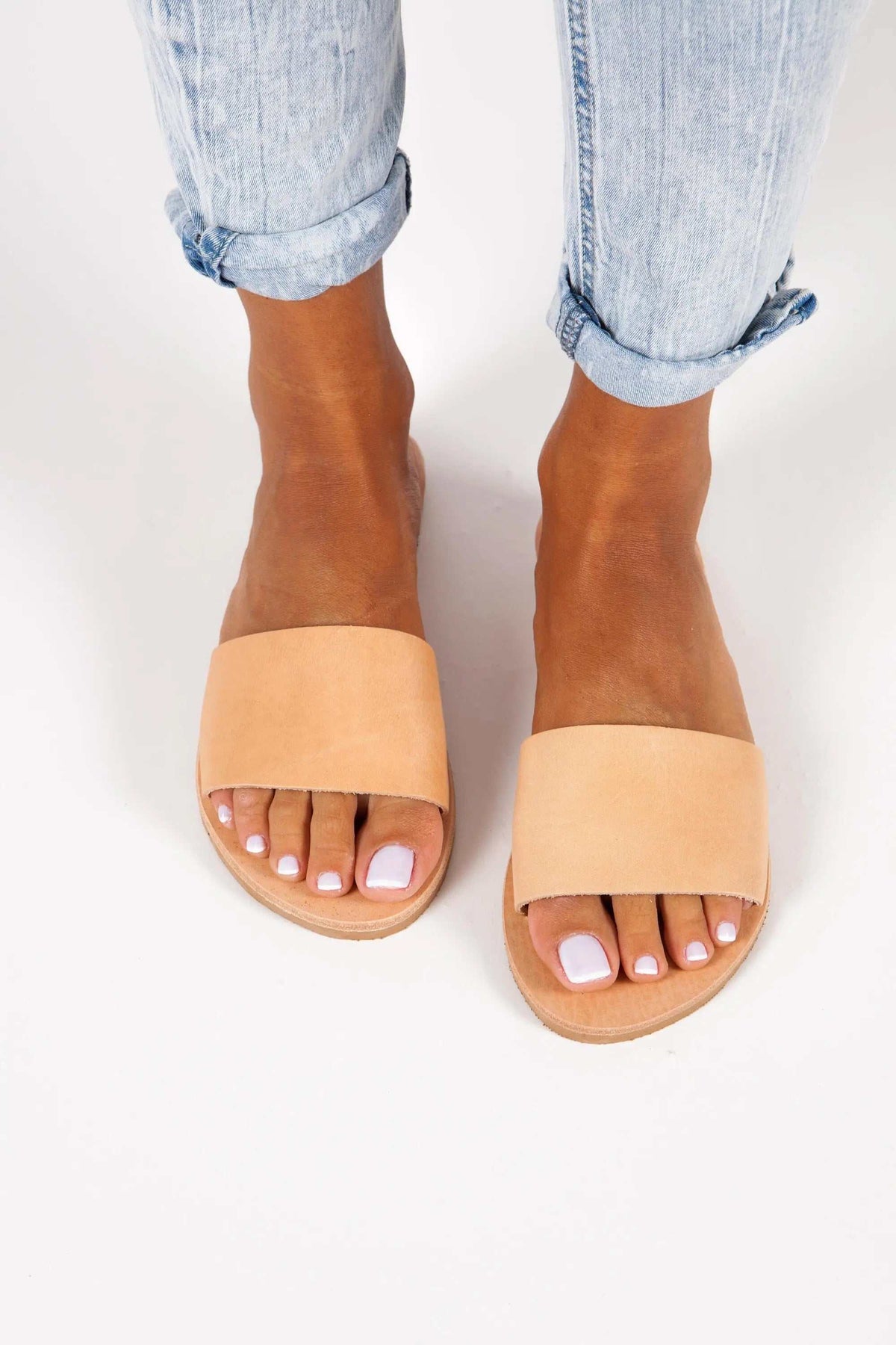 PAROS Handmade Greek Sandals with tan leather insoles and wide pale peach straps in a simple slip-on style