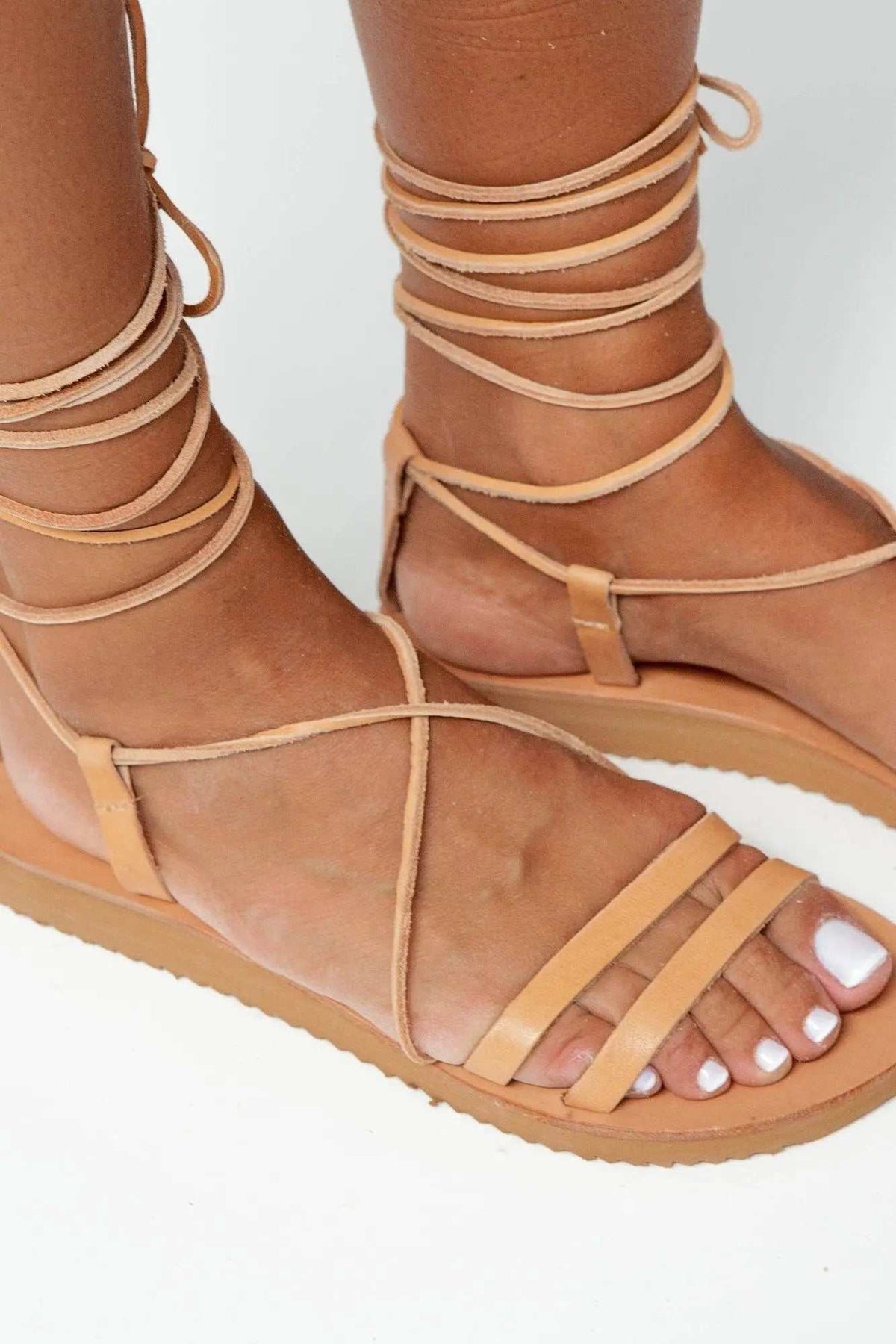 PAXOS Handmade Greek Sandals in natural tan leather with gladiator ankle straps and flat rubber soles