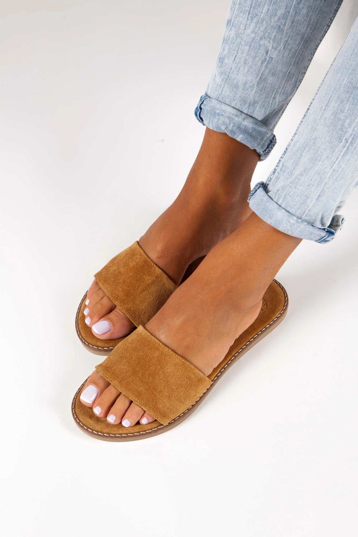 RHODOS Handmade Greek Sandals in mustard-brown suede leather, with wide crossover-free straps and stitched flat soles.