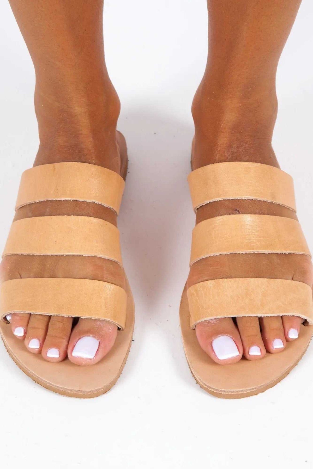 SYROS Handmade Greek Sandals in natural tan leather, with three wide straps, an open toe and flat sole