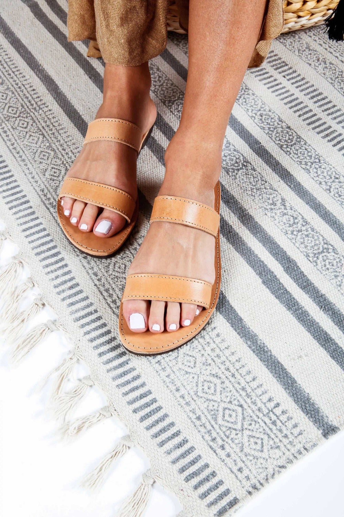 TINOS Handmade Greek Sandals in natural tan leather with wide straps, open toes, and stitched soles