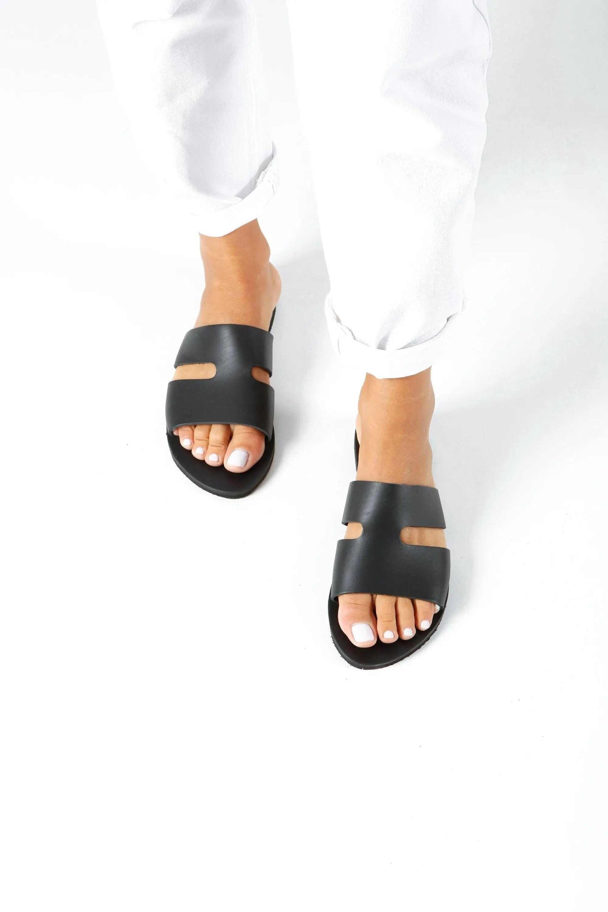 VOTSALO Handmade Greek Sandals in black leather with wide straps, open toes, and small cutout details