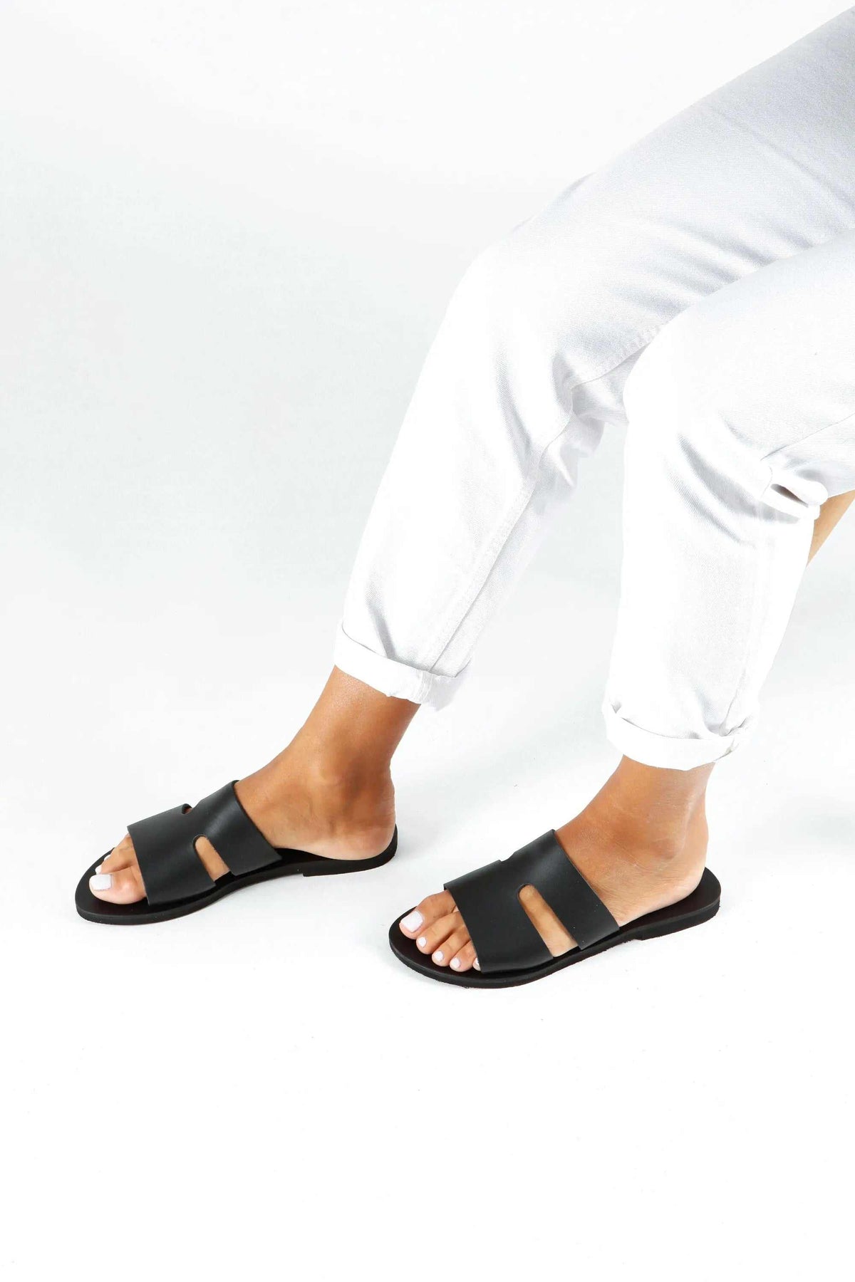 VOTSALO Handmade Greek Sandals in black leather, with wide straps, an open toe and a flat sole