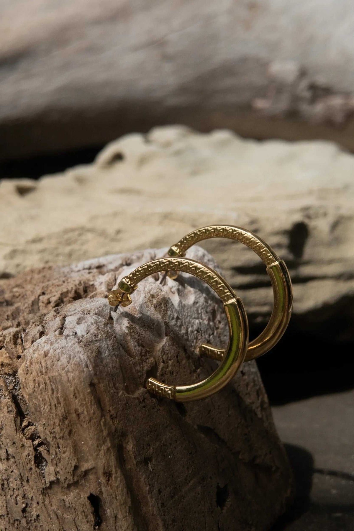24 k gold filled hoops in gold-tone metal with a textured tribal pattern and open hoop design