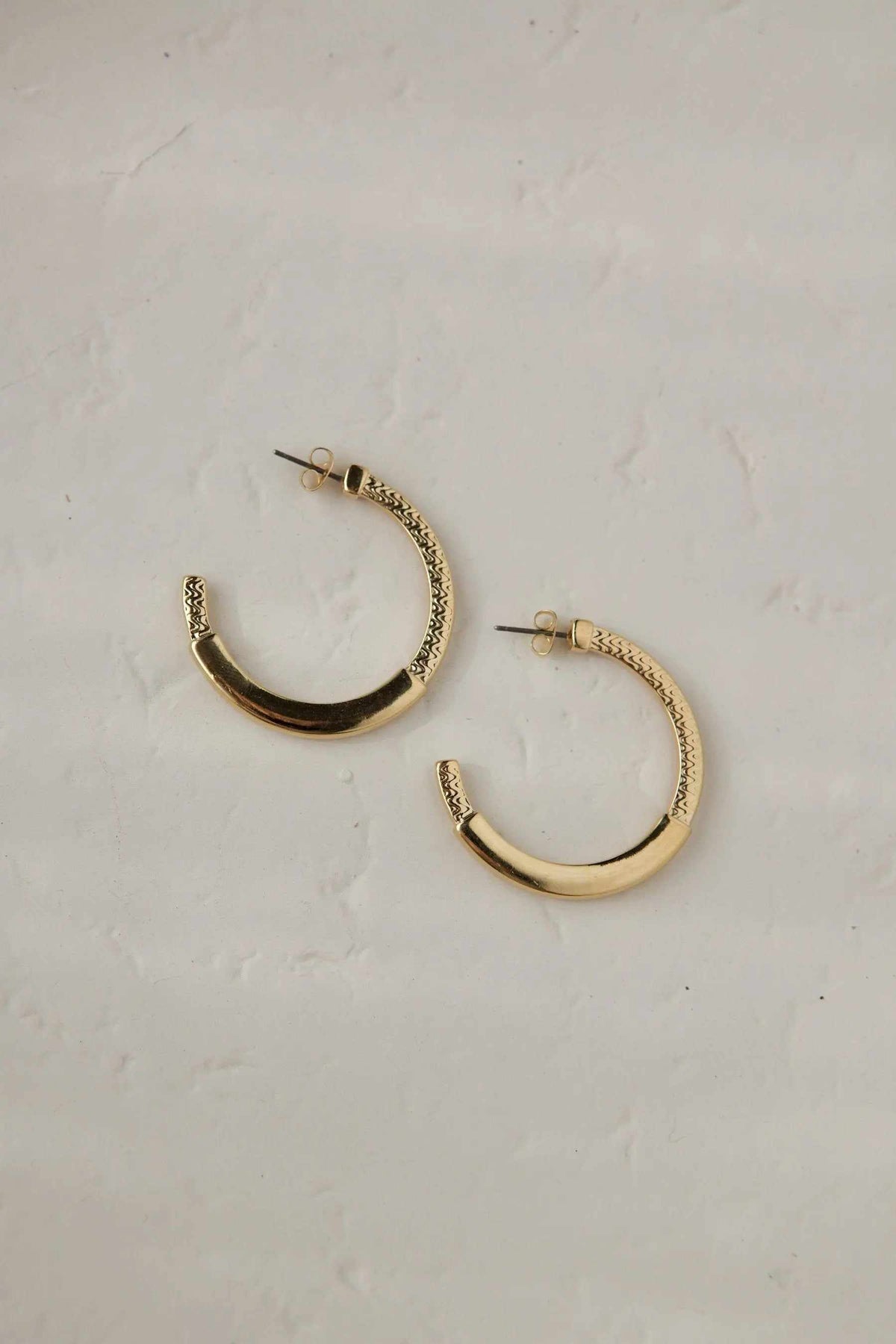24 k gold filled hoops in gold-toned metal with textured tribal pattern and hinged hoop design