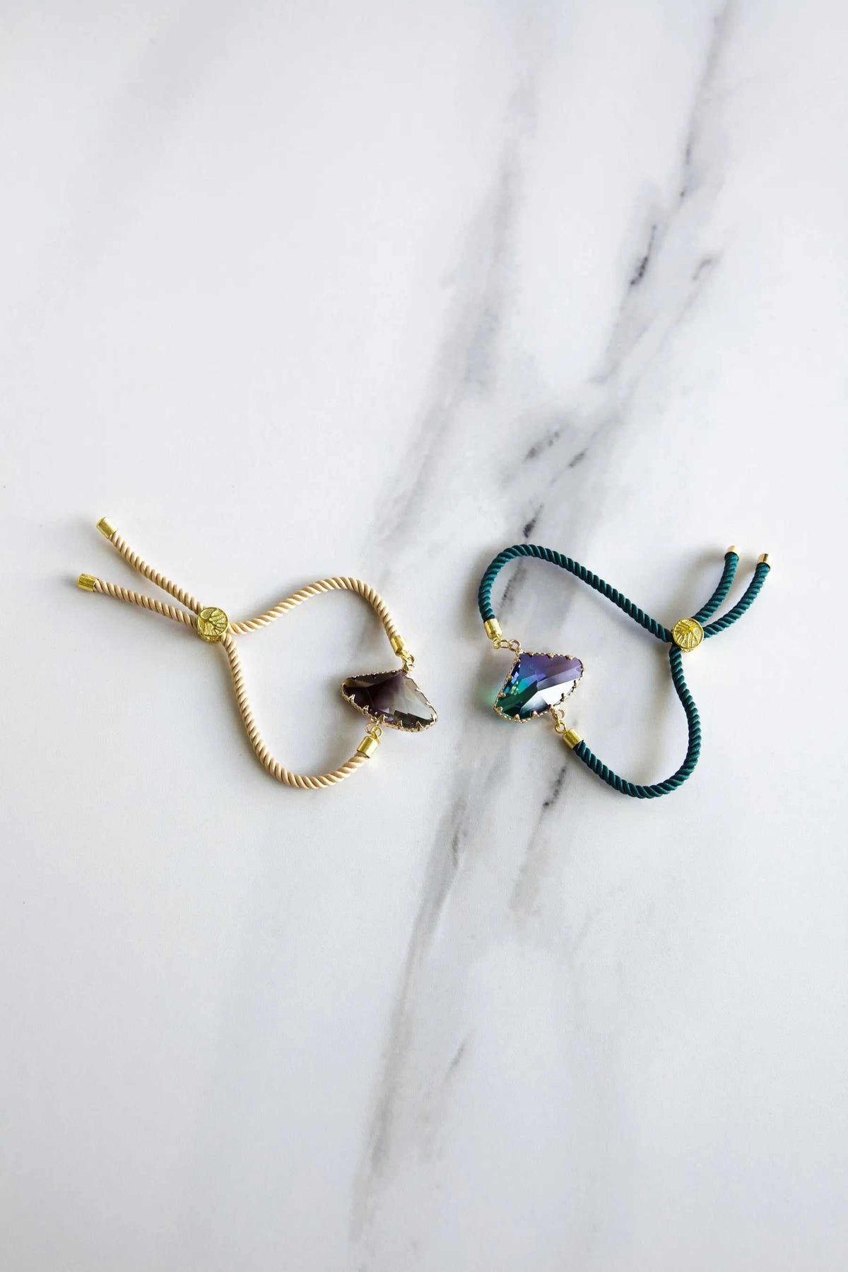 Adjustable Crystal Bracelet with teal and gold twisted cords, iridescent faceted crystal charms, and sliding knots