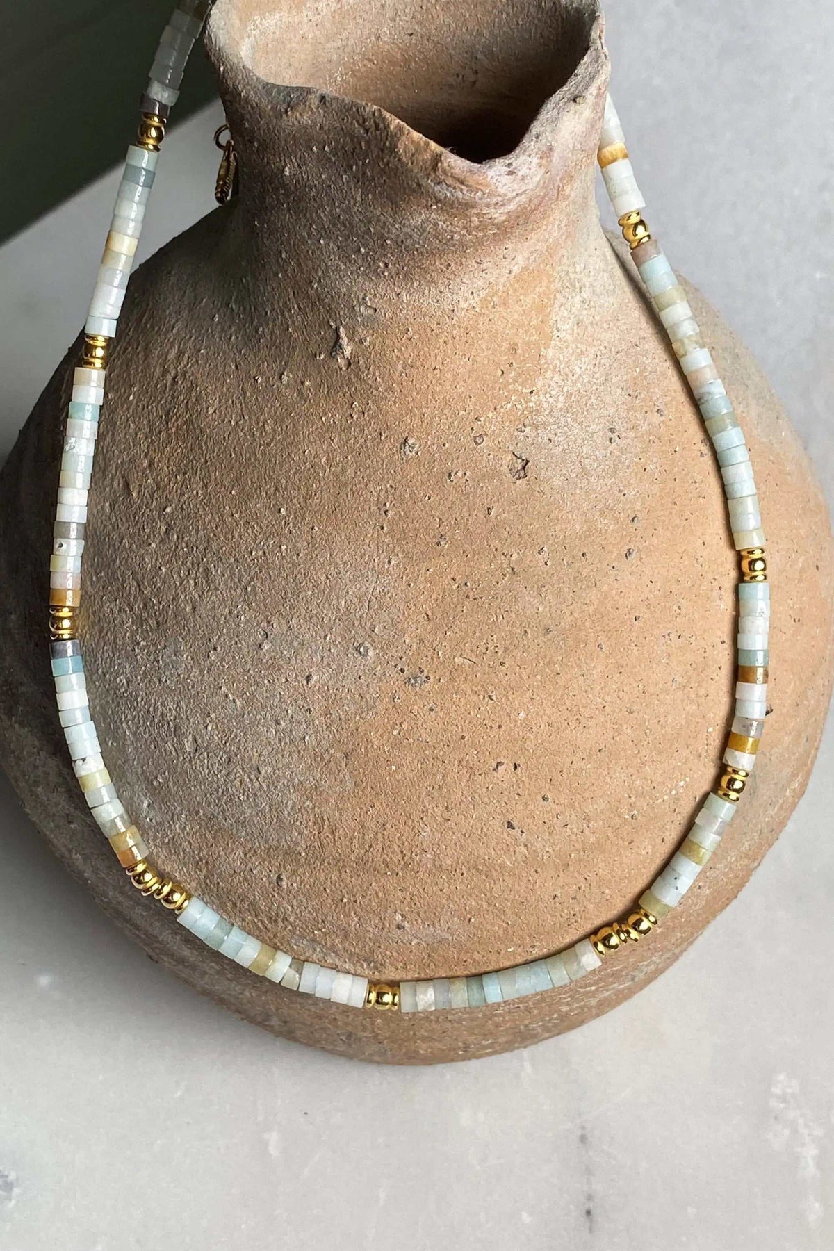 AELIA NECKLACE with pale aquamarine beads, gold-plated accents, and a delicate beaded design