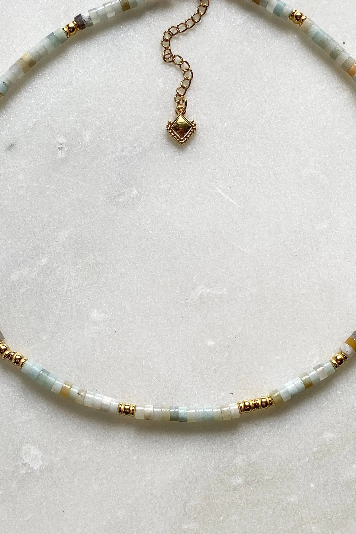 AELIA NECKLACE with pale aquamarine beads, gold-plated accents, and a decorative pendant