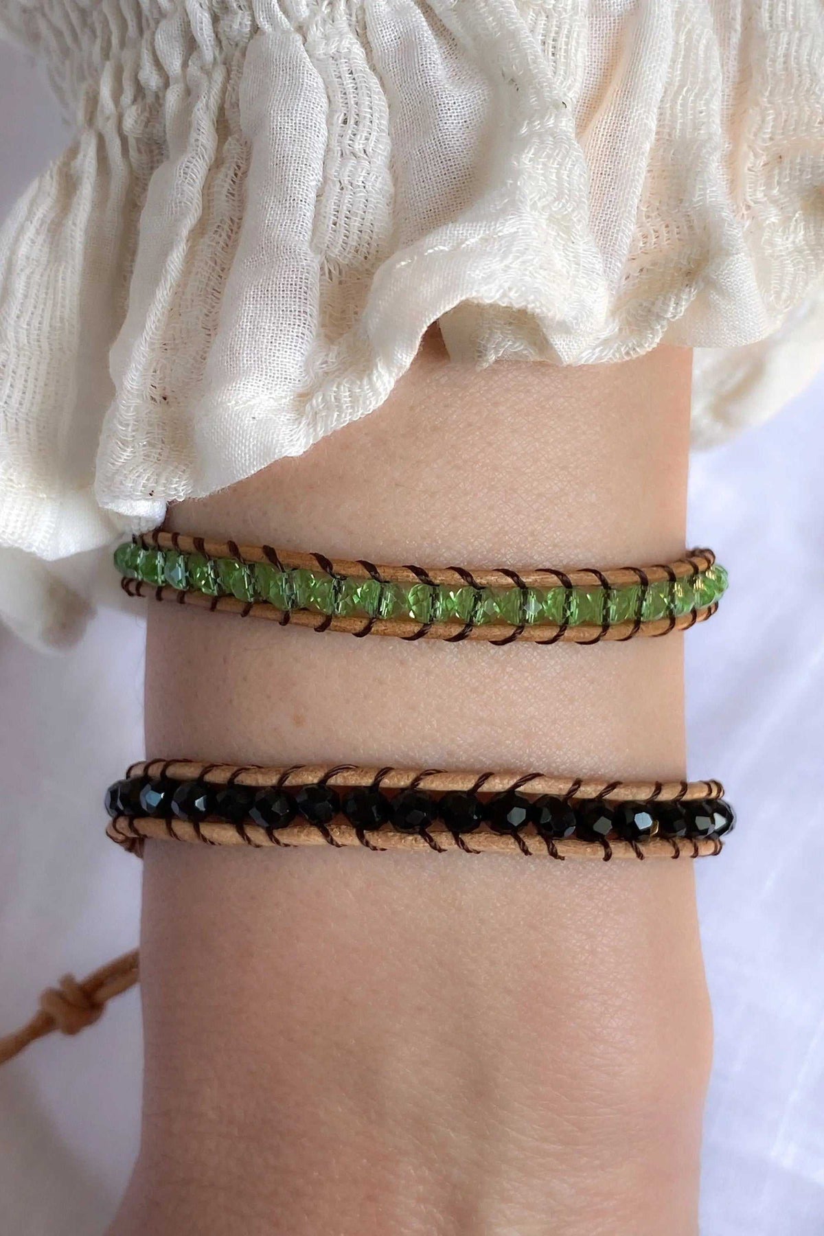 AGAPI BRACELET set of two woven leather bands, one green with dark accents and one black with light beads