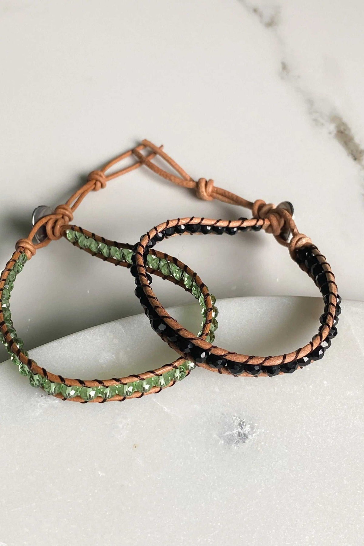 AGAPI BRACELET in tan leather with black and light green crystal beads, featuring adjustable knotted closures