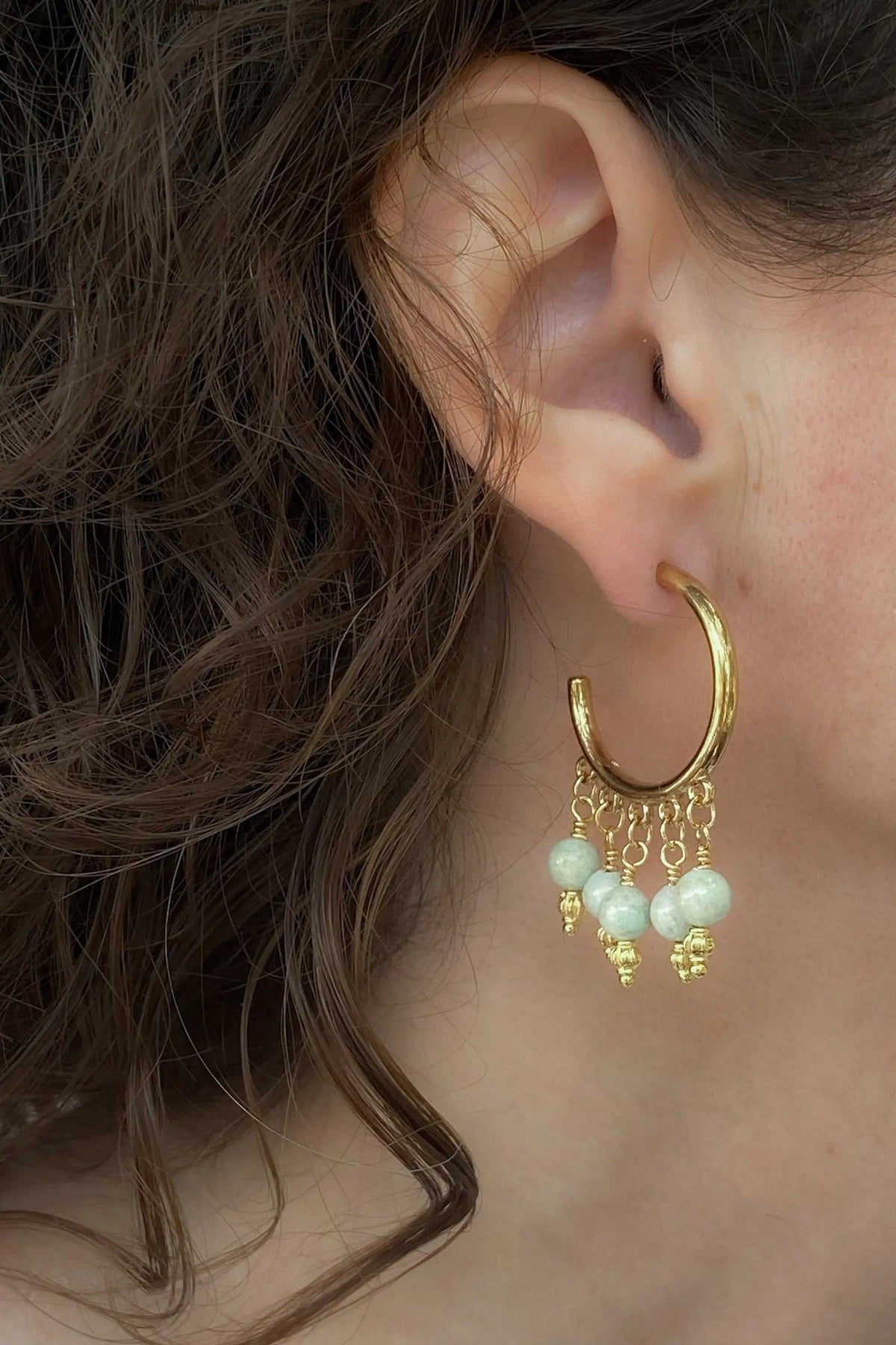 ALEX EARRINGS gold hoop earring with pale green gemstones and dangling textured charms