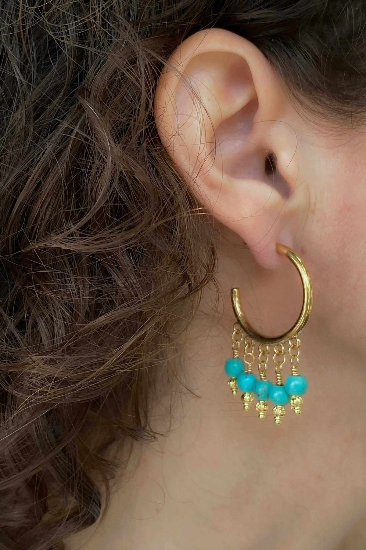 ALEX EARRINGS are gold-tone hoop earrings with bright turquoise beads and delicate dangling gold chains.