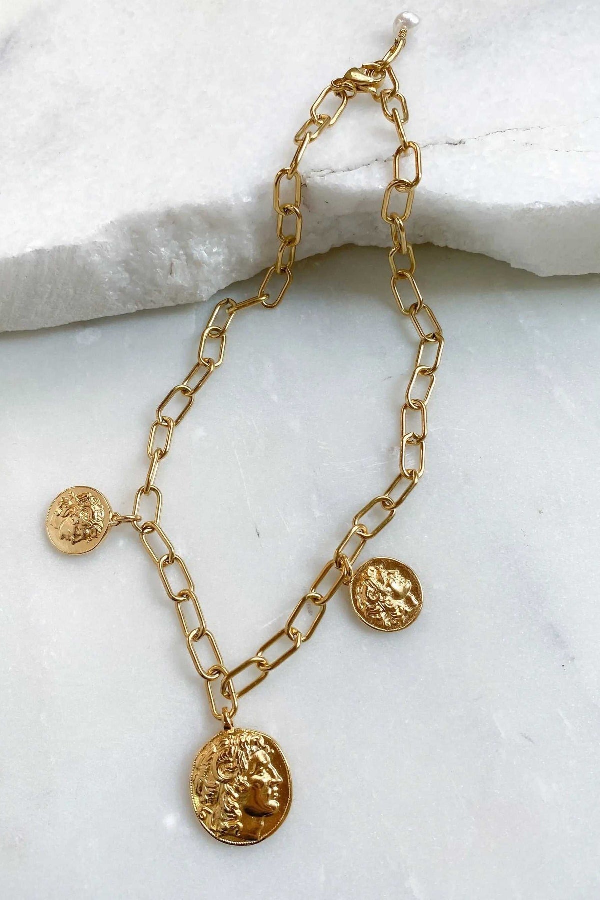 Alexander Charm Bracelet in gold-tone metal with an open-link chain and three raised coin charms featuring classical figures.