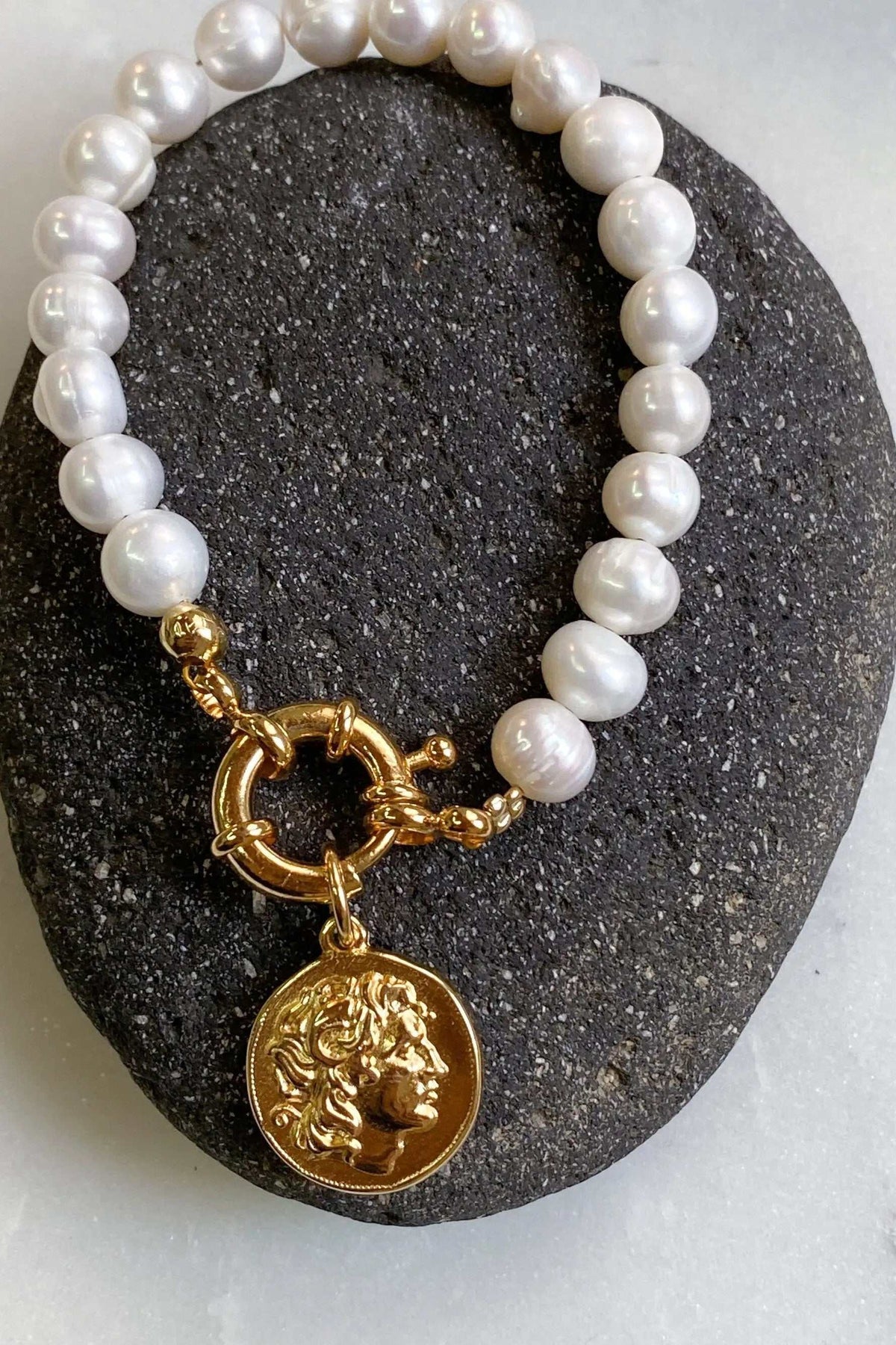 Alexander the Great pearl bracelet with lustrous white freshwater pearls, gold-tone links and an embossed ancient coin pendant