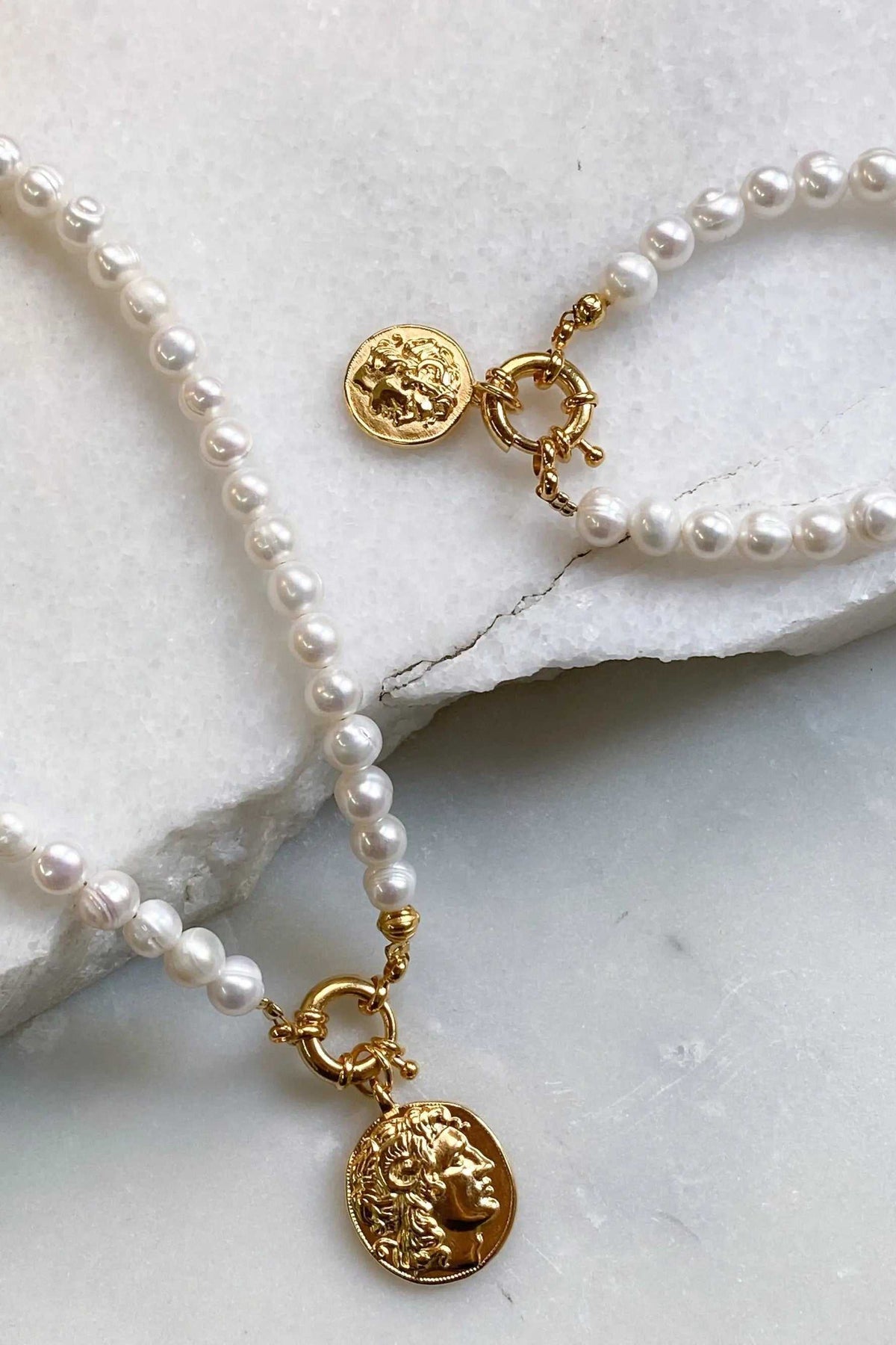 Alexander the Great pearl bracelet with lustrous white freshwater pearls, gold-tone links and embossed coin charms